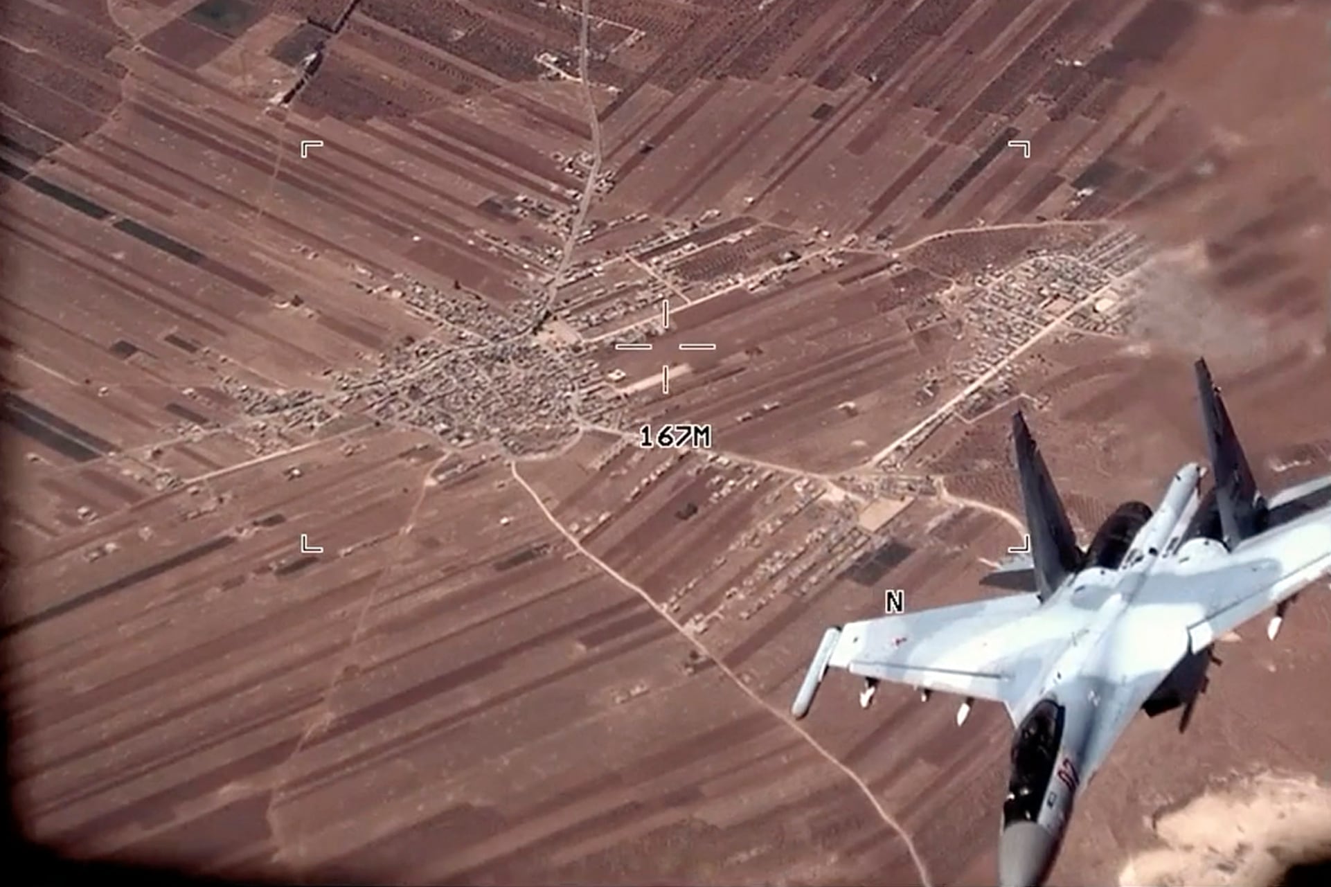 In this image from video released by the U.S. Air Force, a Russian SU-35 flies near a U.S. Air Force MQ-9 Reaper drone on Wednesday, July 5, 2023, over Syria.