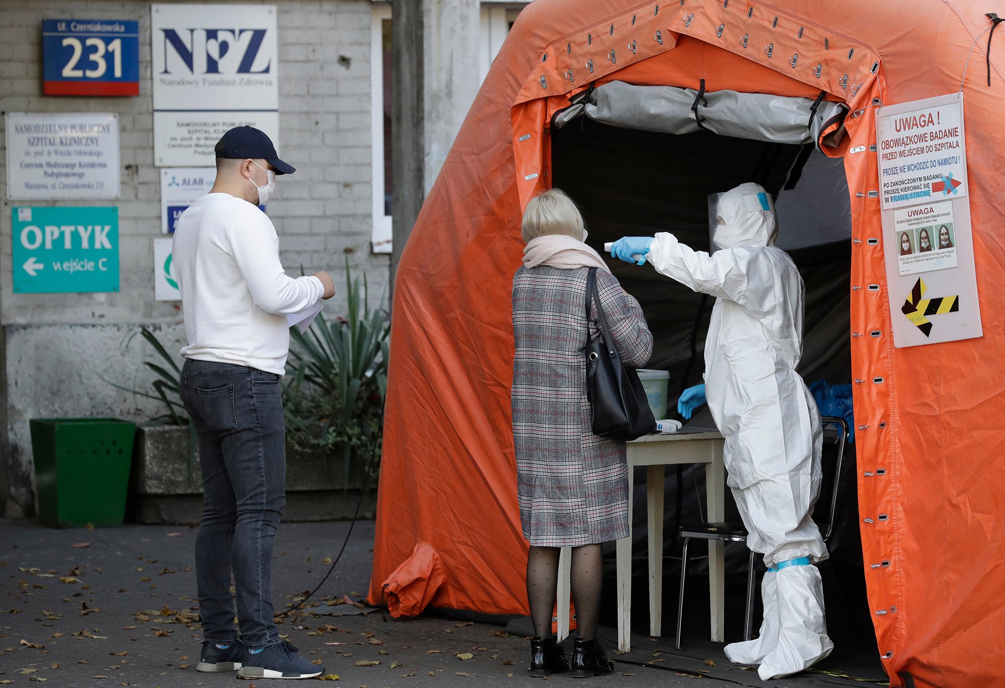 People arrive to be tested for COVID-19 in Warsaw, Poland, Thursday, Oct. 22, 2020.