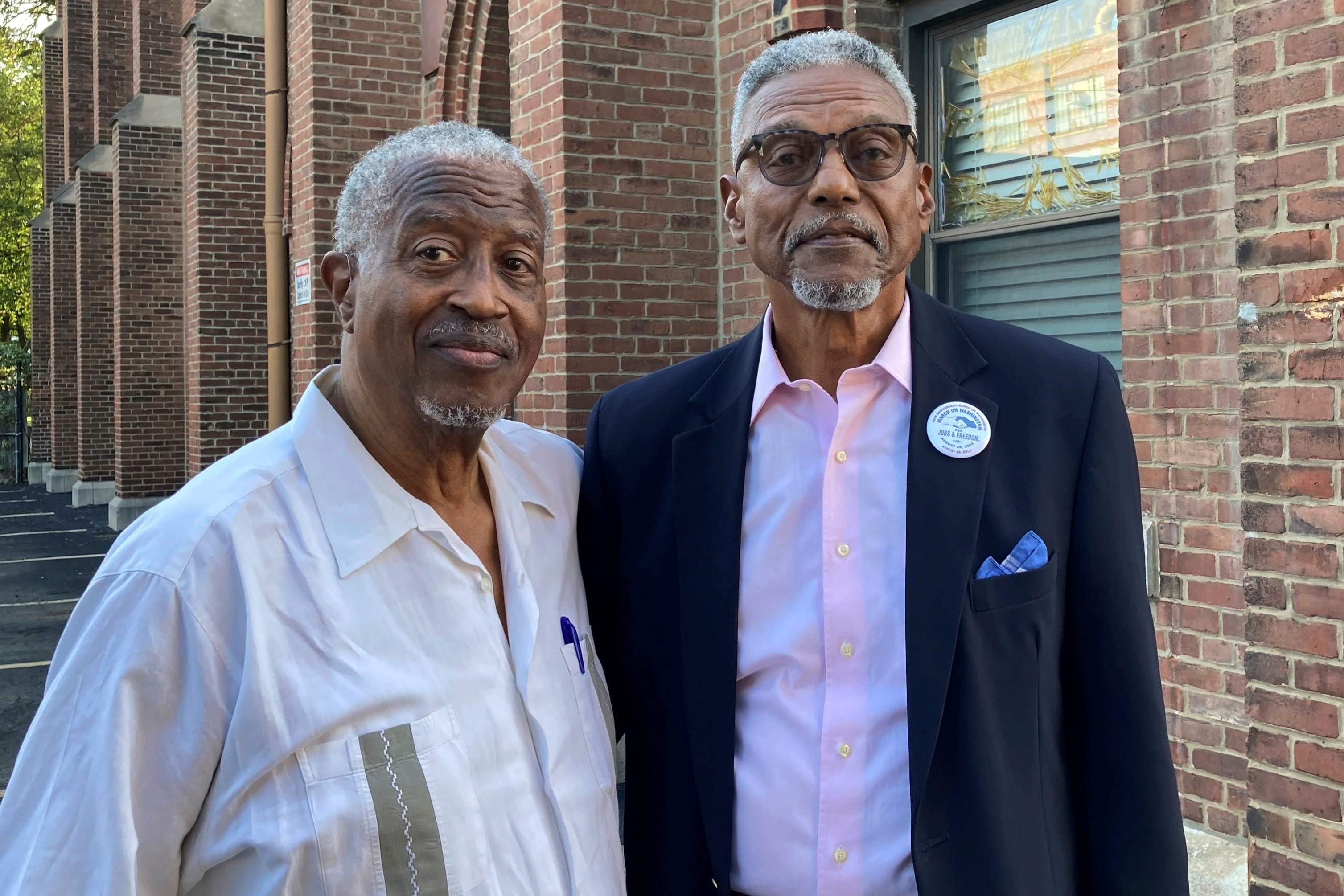 Chester Deanes, left, and Ben Phillips hold a photo of the former Pruitt-Igoe housing development in St. Louis, where they lived growing up on Sept. 7, 2023.