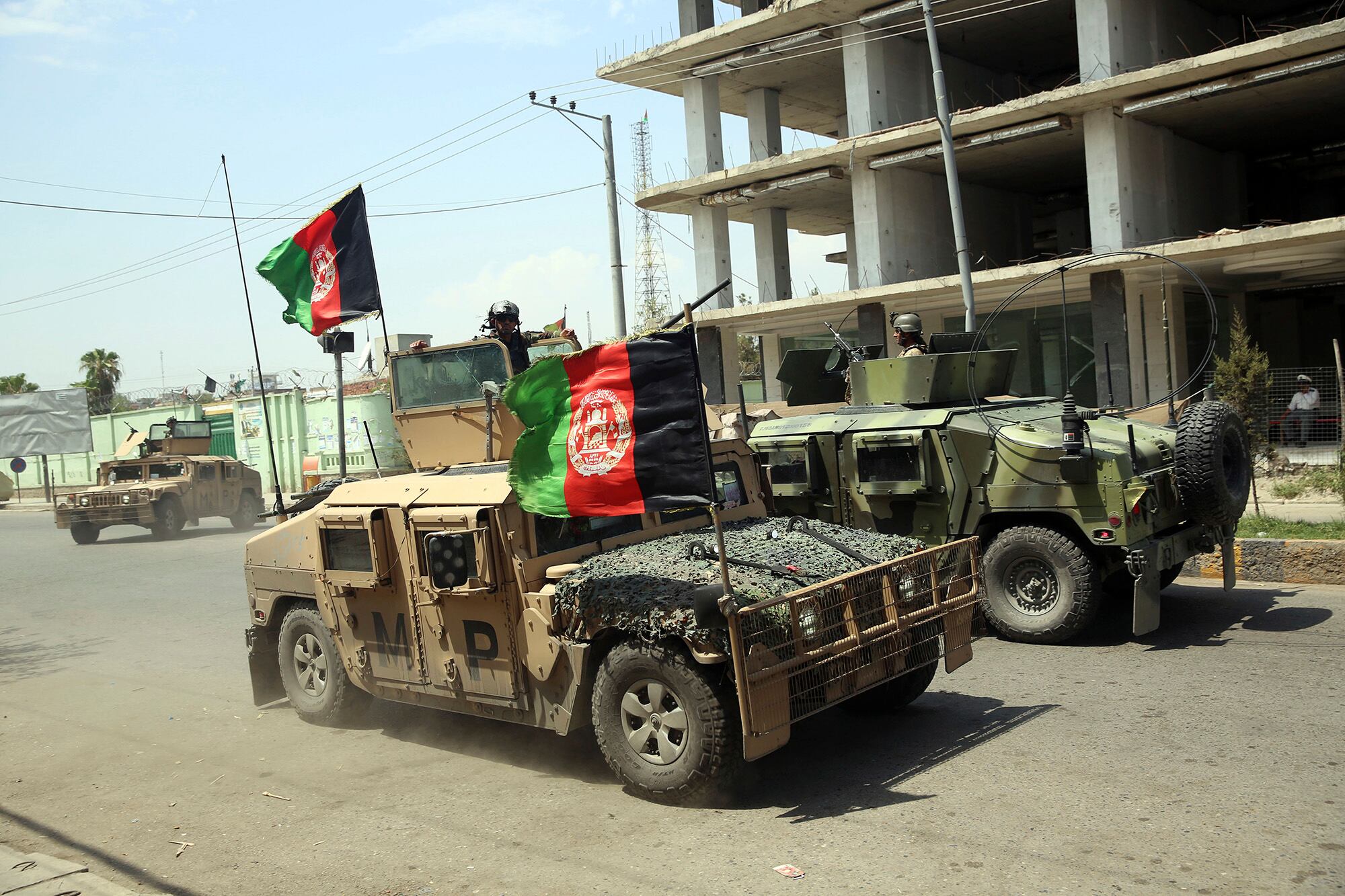 In this Aug. 3, 2020, file photo, Afghan security personnel gather near a prison after an attack in the city of Jalalabad, east of Kabul, Afghanistan.