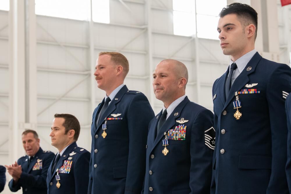 Air Force Reserve Command deputy commander Maj. Gen. Matthew J. Burger, the former boss of the 349th Air Mobility Wing,  awards the Distinguished Flying Cross to four C-17A Globemaster III aircrew members during a ceremony at Travis Air Force Base, Calif., Apr. 1, 2022. Burger presented the medals to Lt. Col. Dominic Calderon, 1st Lt. Kyle Anderson and Master Sgt. Silva Foster from the 301st Airlift Squadron, and Senior Airman Michael Geller of the 517th Airlift Squadron (L-R). (Grant Okubo/Air Force)