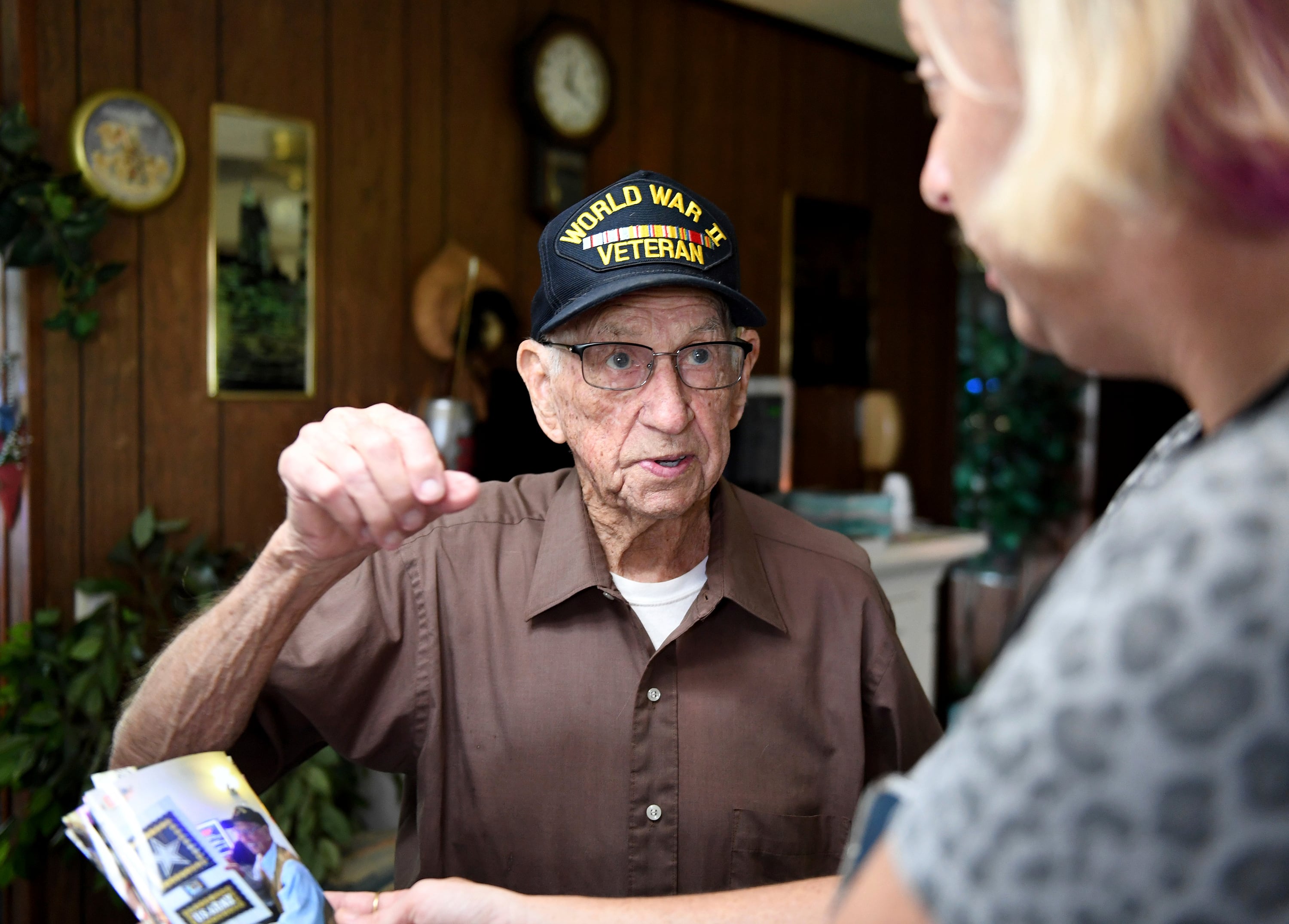 Ernest Marvel, WWII Army Veteran, shows off photos from a party Aug. 2, 2022, in Frankford, Del.