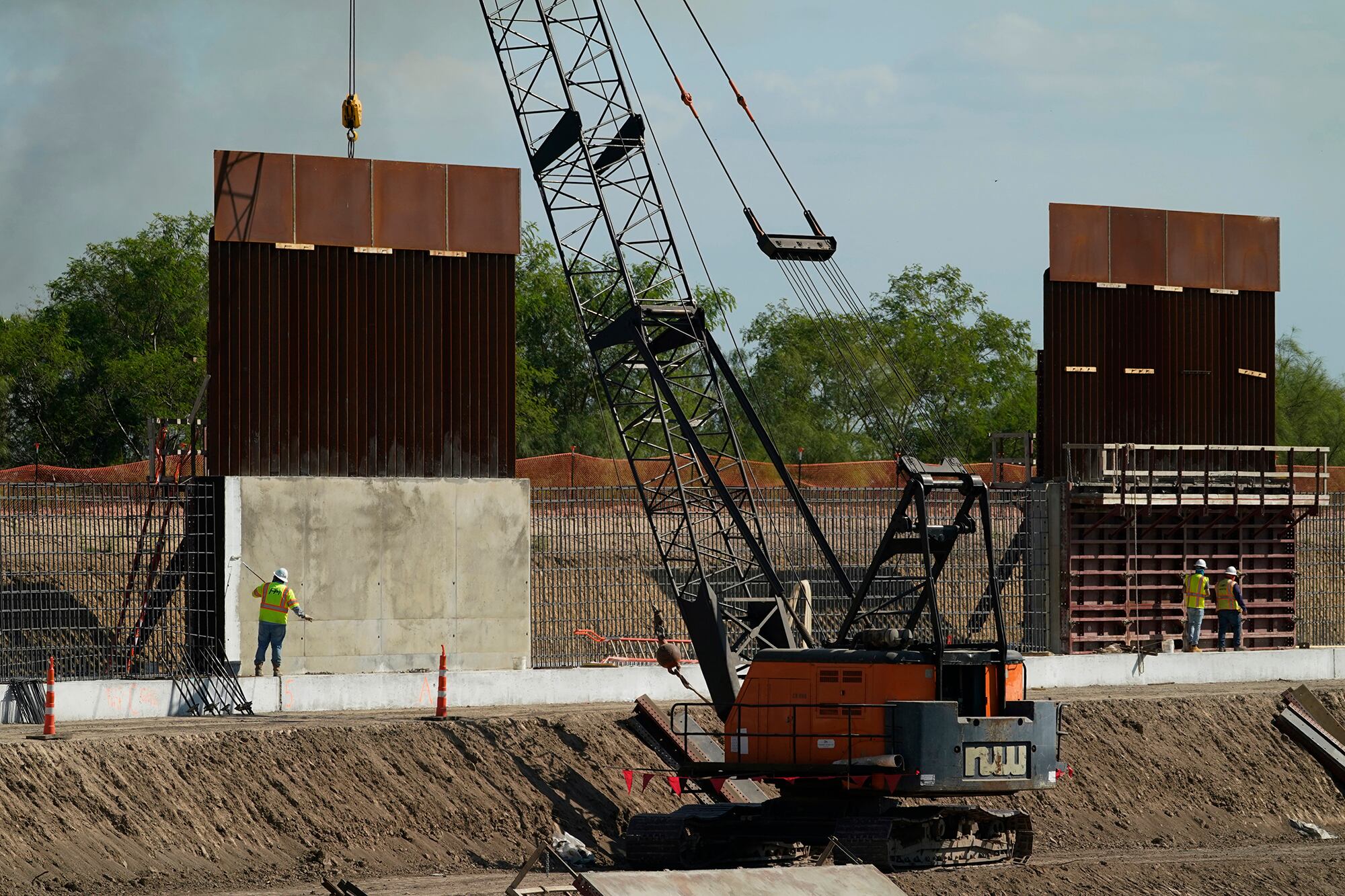 Construction workers build a border wall in Mission, Texas, Monday, Nov. 16, 2020.