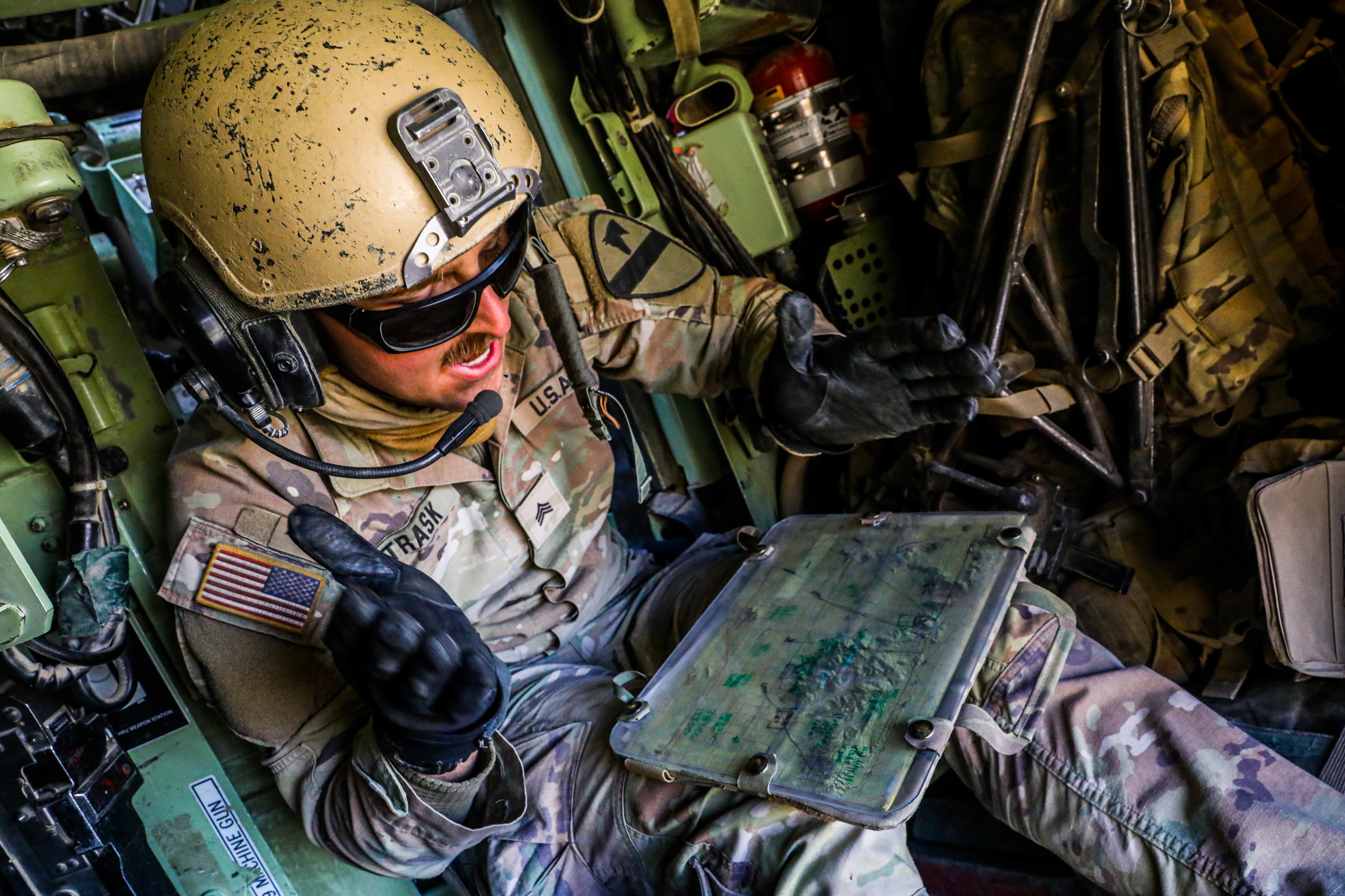 Sgt. Michael Trask calls out grid coordinates during Project Convergence  22 at Fort Irwin, California. Opposing forces were spotted using a Raven drone.