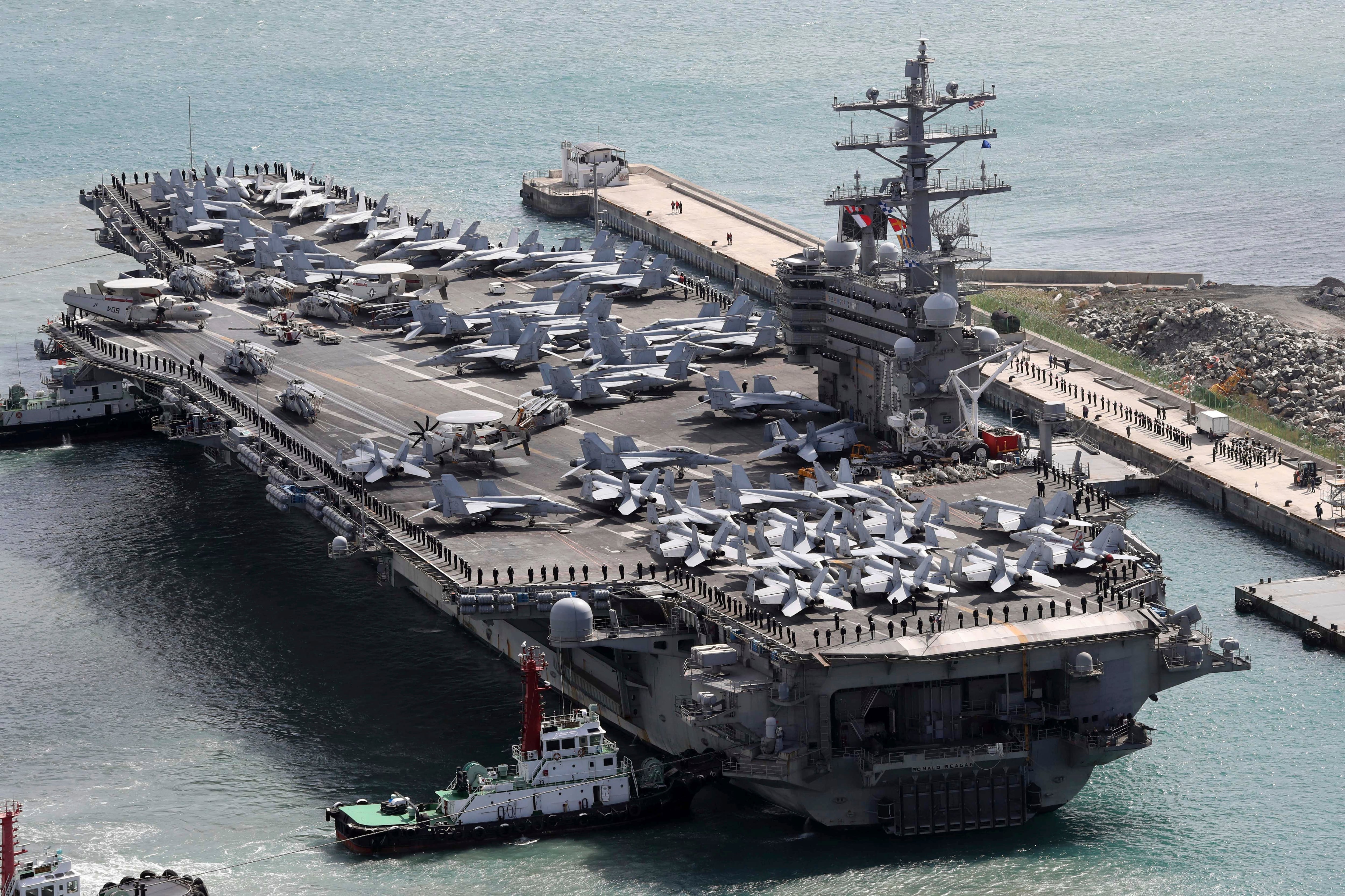 The aircraft carrier Ronald Reagan is escorted into Busan port, South Korea, after completing a joint drill with the South Korean military on Oct. 21, 2017.