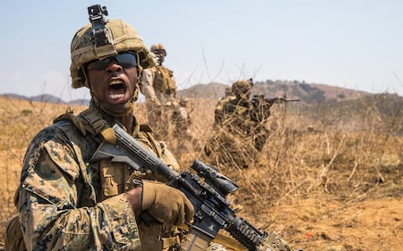 Marine Corps Lance Cpl. Joshua Anderson relays commands to his fire team while conducting offensive operations during the Supersquad 2020 Competition at Marine Corps Base Camp Pendleton, Calif., Aug. 20, 2020.