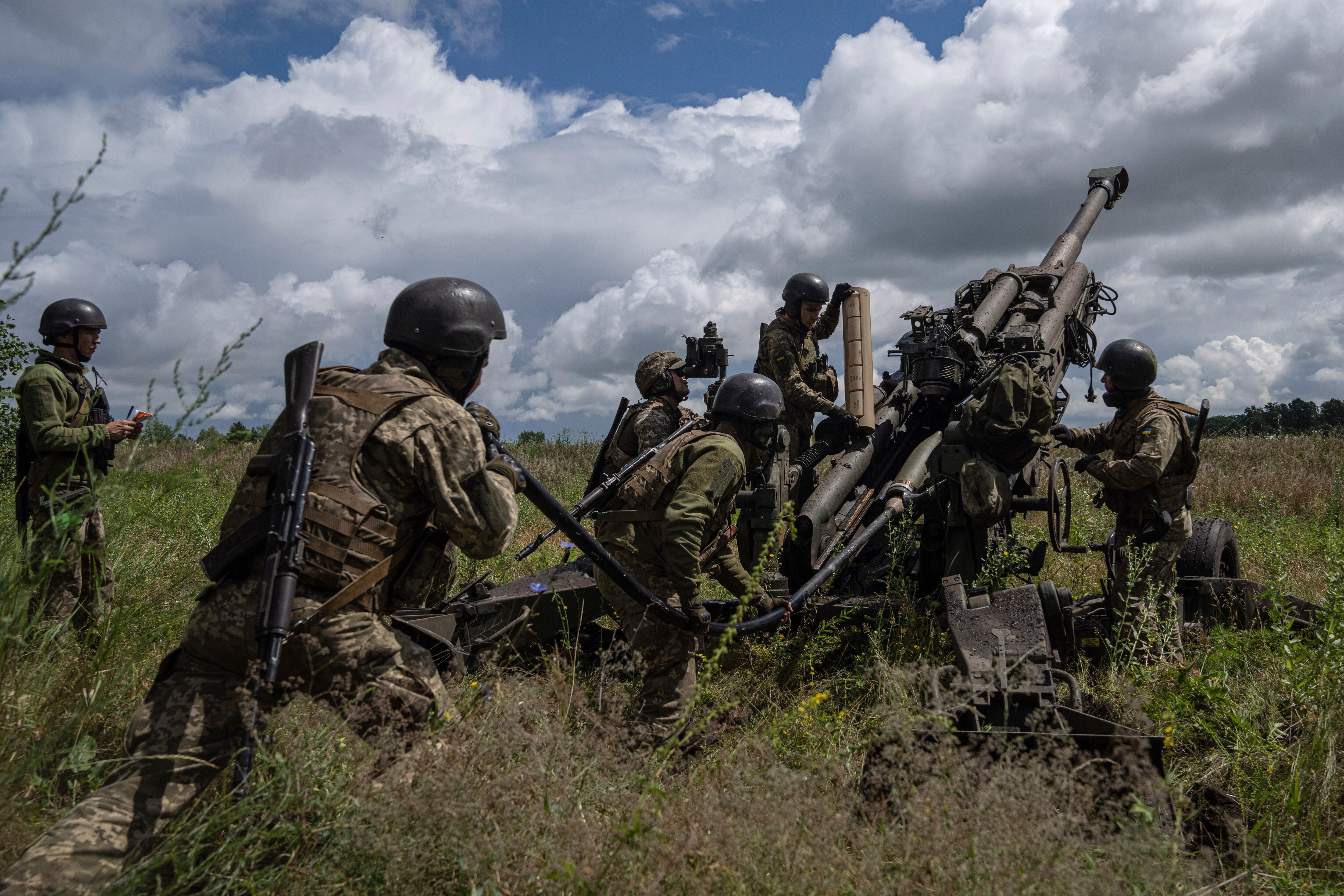 Ukrainian servicemen prepare to fire at Russian positions from a U.S.-supplied M777 howitzer in Kharkiv region, Ukraine, July 14, 2022.