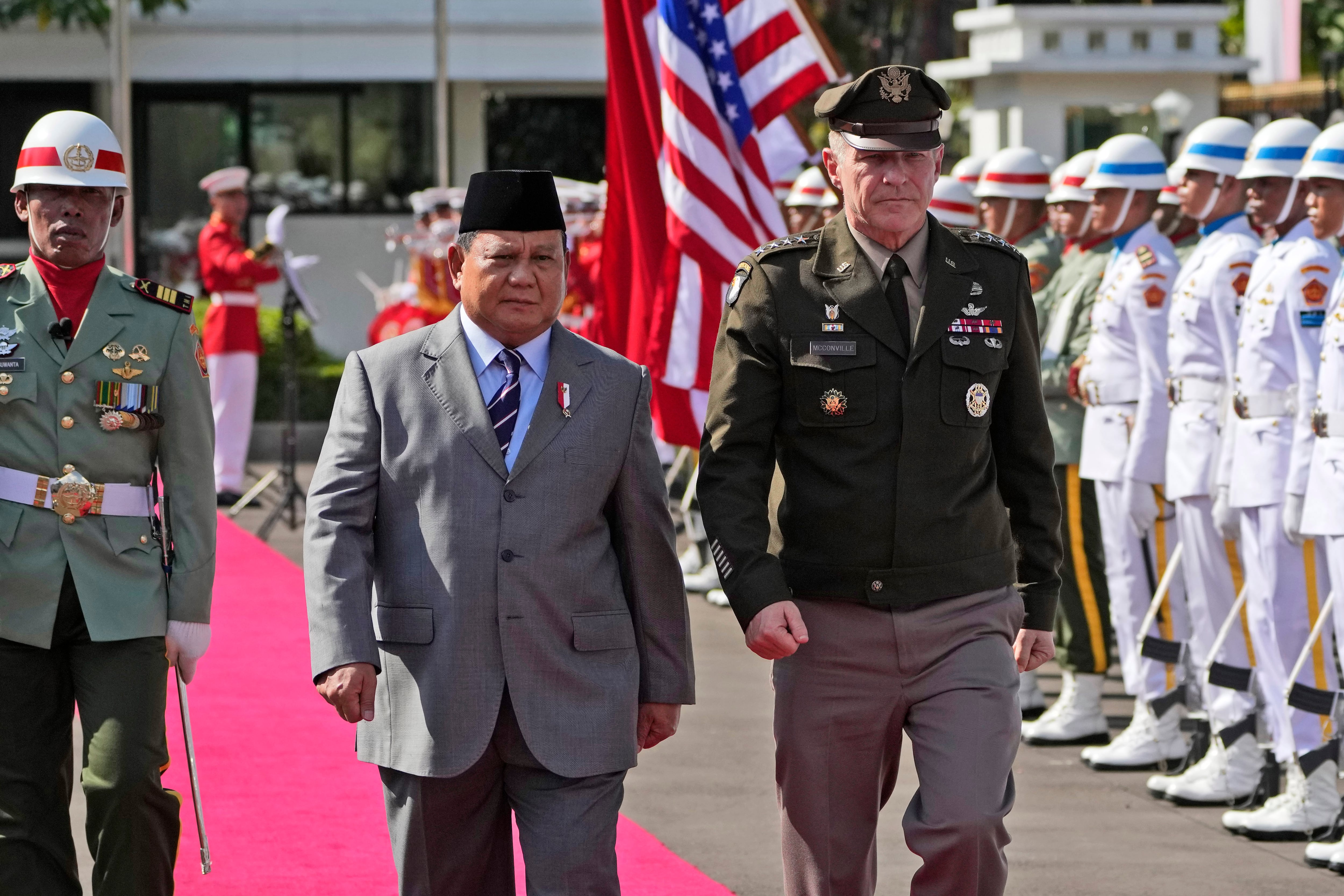 U.S. Army Chief of Staff Gen. James McConville, right, and Indonesian Defense Minister Prabowo Subianto inspect an honor guards during their meeting in Jakarta, Indonesia, Friday, May 12, 2023.