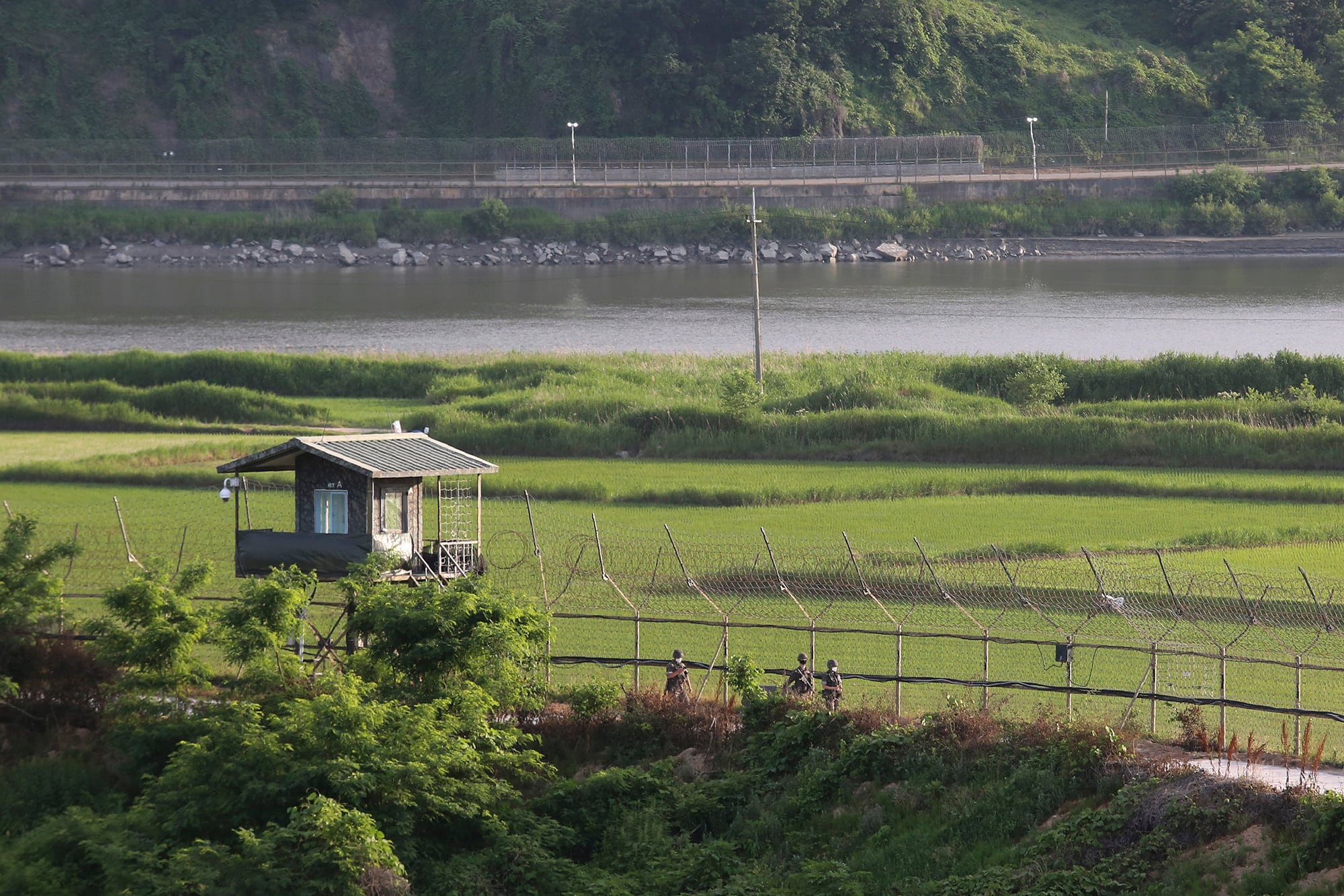 South Korean army soldiers patrol along the barbed-wire fence in Paju, South Korea, near the border with North Korea, Monday, June 15, 2020.