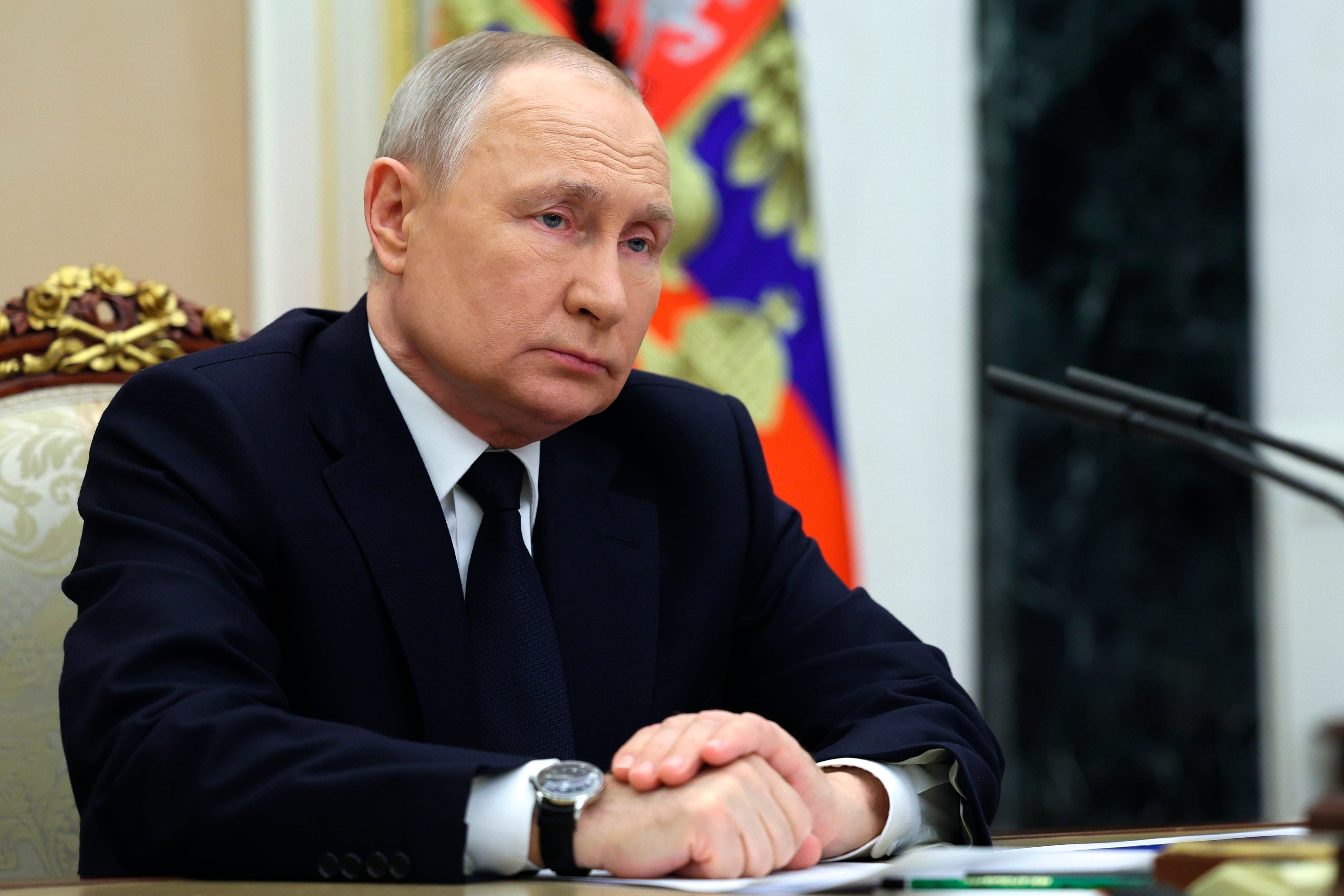 Russian President Vladimir Putin listens to Russian Transport Minister Vitaly Savelyev during their meeting in Moscow, Russia, Saturday, March 25, 2023.