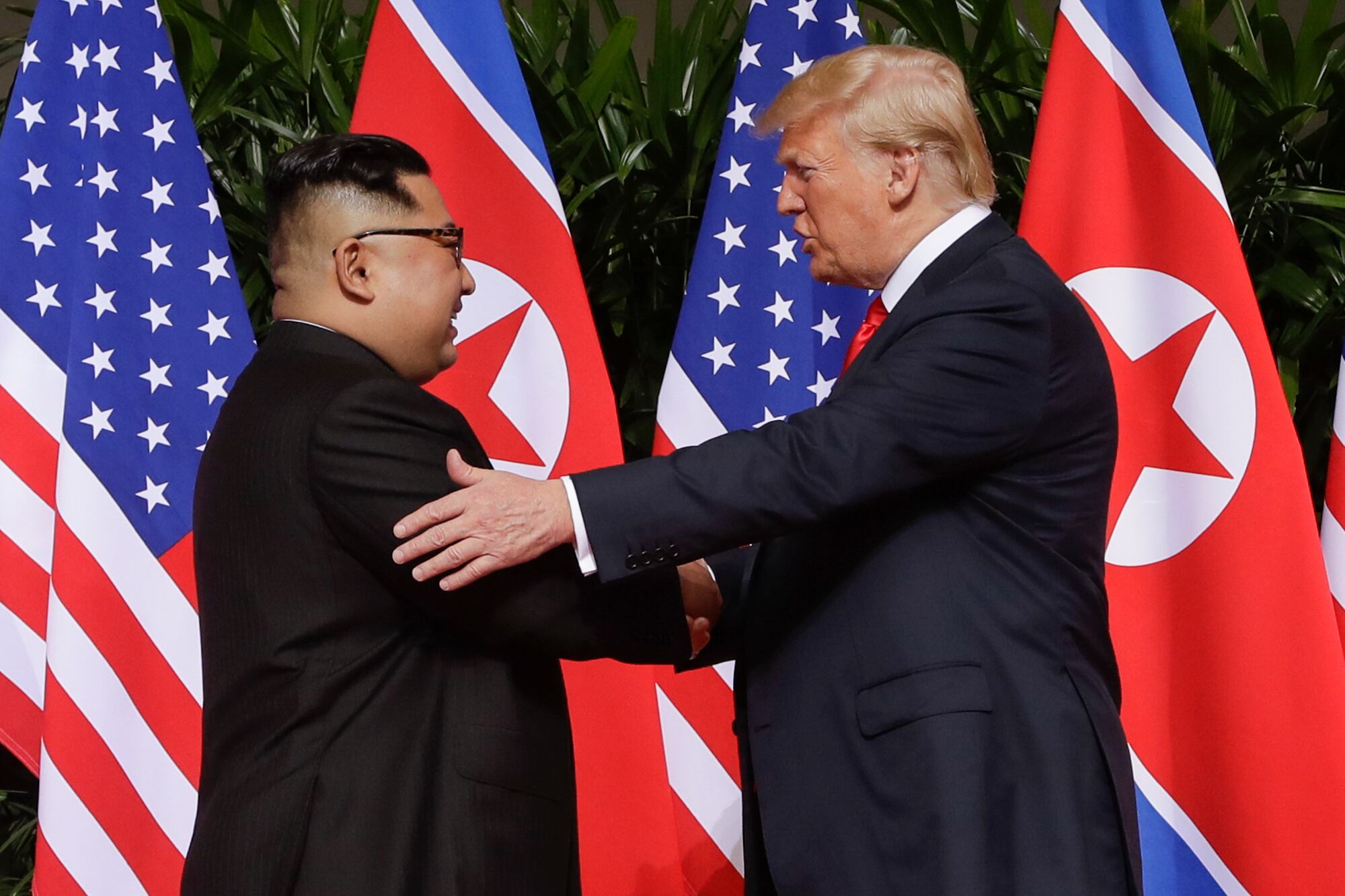 In this June 12, 2018, file photo, President Donald Trump, right, shakes hands with North Korea leader Kim Jong Un at the Capella resort on Sentosa Island in Singapore.