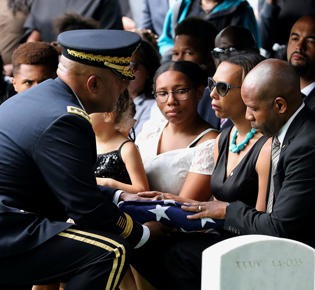 The folded American Flag is presented to West Point Cadet Christopher J. Morgan's parents, April and Christopher by Superintendent Darryl Williams, during the interment ceremony at West Point, N.Y.