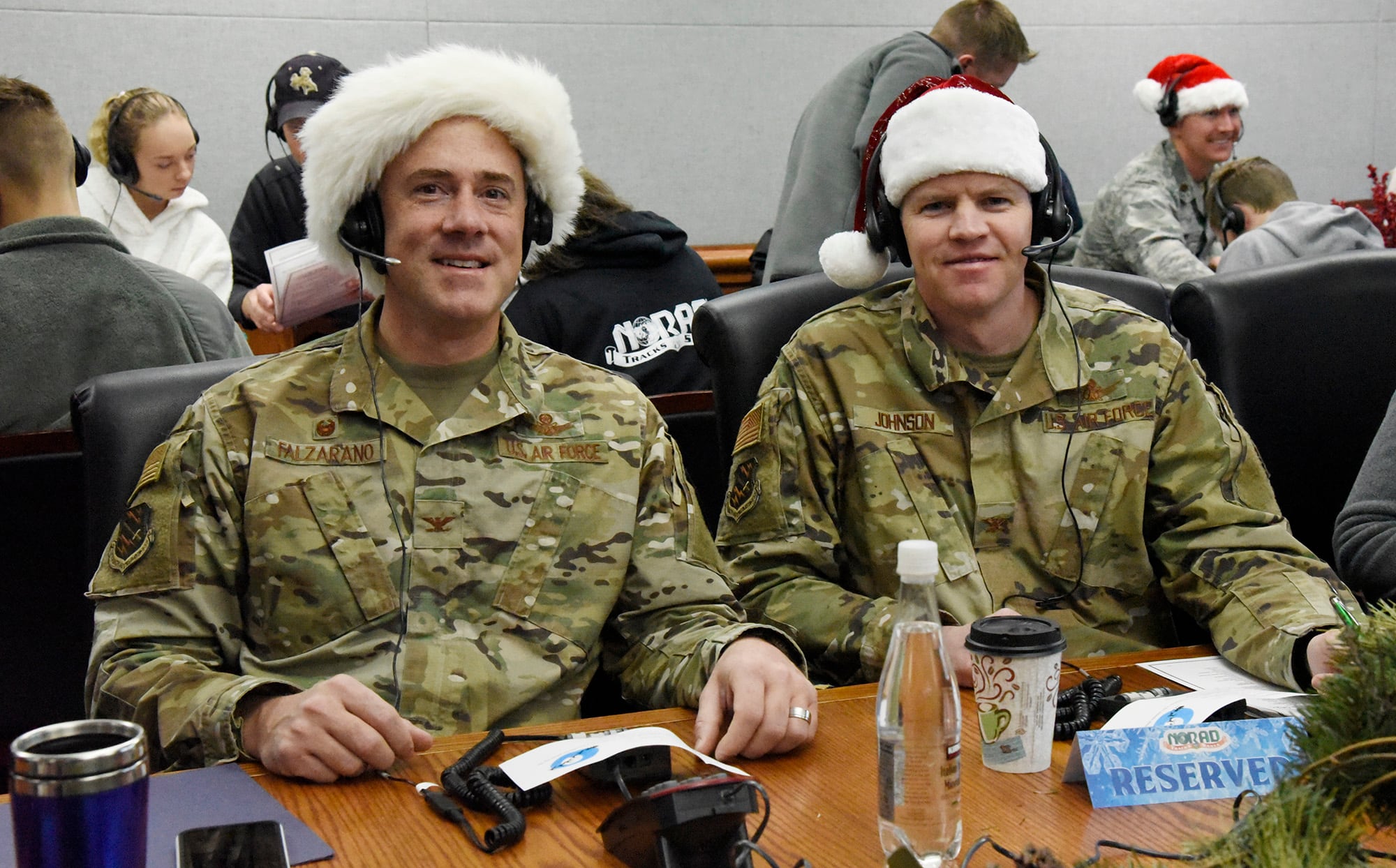 Col. Thomas Falzarano, 21st Space Wing commander, and Col. Sam Johnson, 21st SW vice commander, volunteer as official NORAD Santa Trackers at the 2019 NORAD Tracks Santa Operation Center on Peterson Air Force Base, Colo., on Dec. 24, 2019.