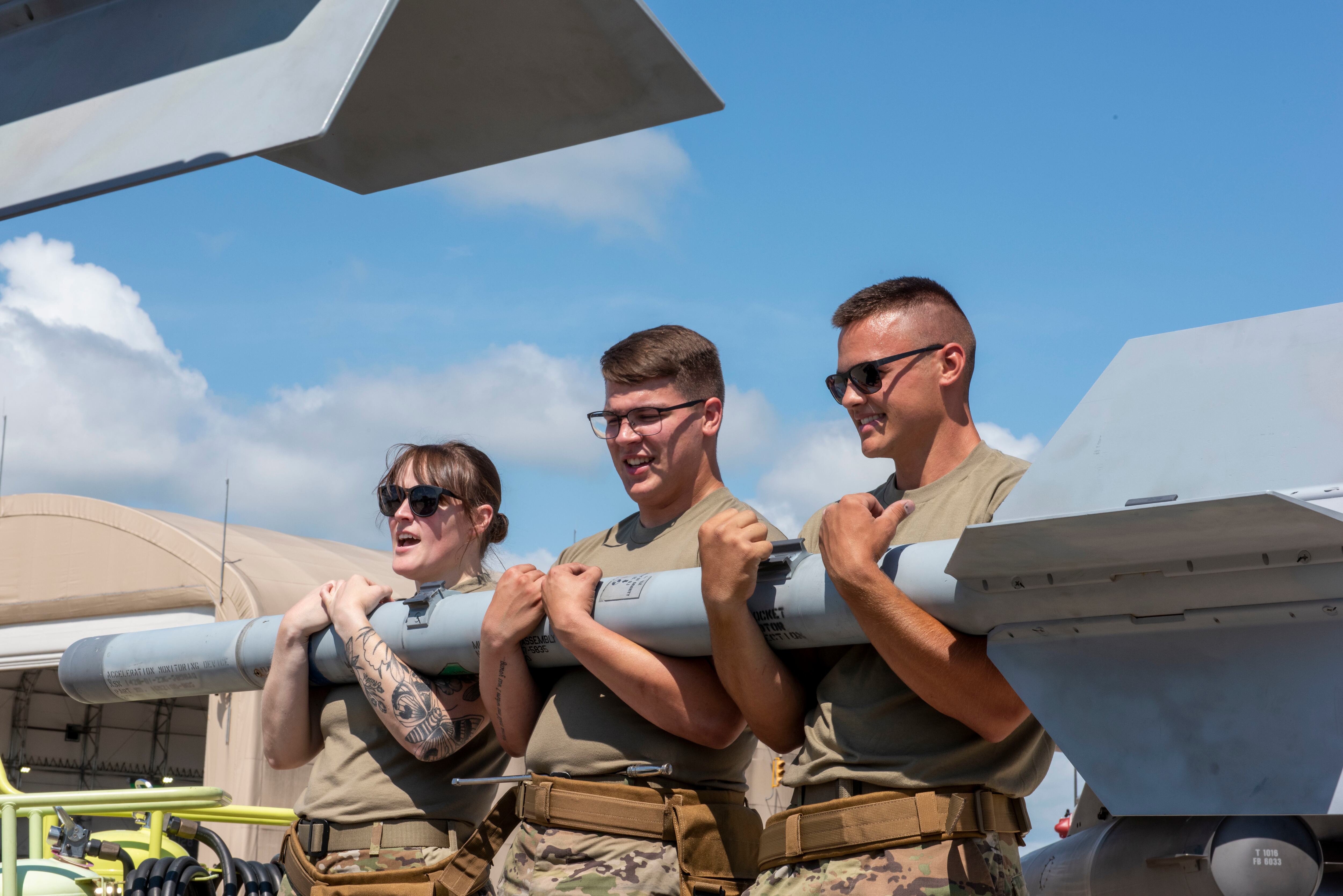 Tech. Sgt. Jordyn Rayot, Airman 1st Class Cole Whitmore and Airman 1st Class Jason Wilson, weapons loaders assigned to the 180th Fighter Wing, remove munitions from an F-16 Fighting Falcon during a training exercise in Swanton, Ohio, Aug. 2, 2022. The 180th FW is the only F-16 fighter wing in the state of Ohio, whose mission is homeland protection, effective combat power, and defense support to civil authorities, while developing airmen, supporting their families and serving in the community. (Tech. Sgt. John Wilkes/Air National Guard)