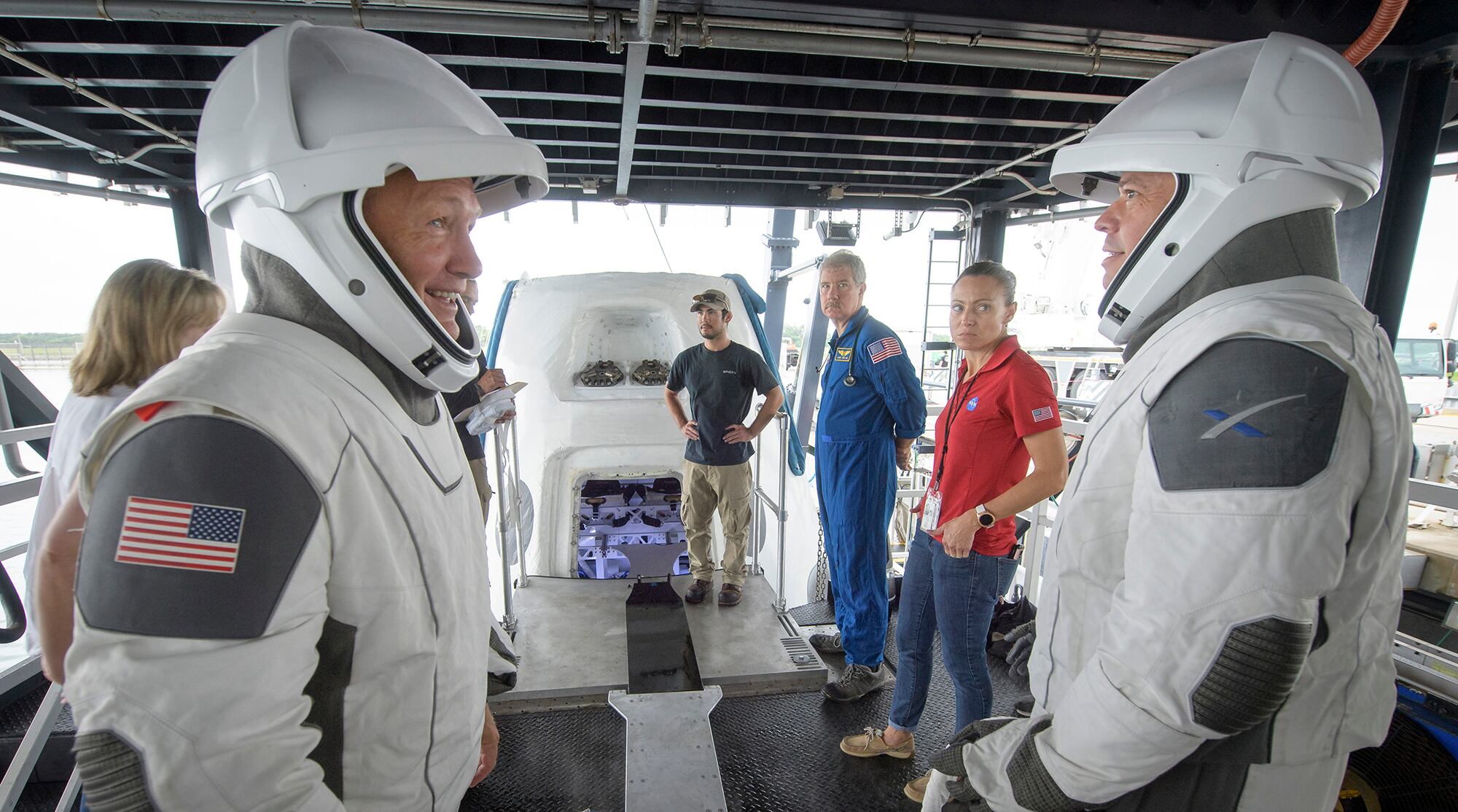 In this Aug. 13, 2019, file photo, NASA astronauts Doug Hurley, left, and Bob Behnken work with teams from NASA and SpaceX to rehearse crew extraction from SpaceX's Crew Dragon at the Trident Basin in Cape Canaveral, Fla.