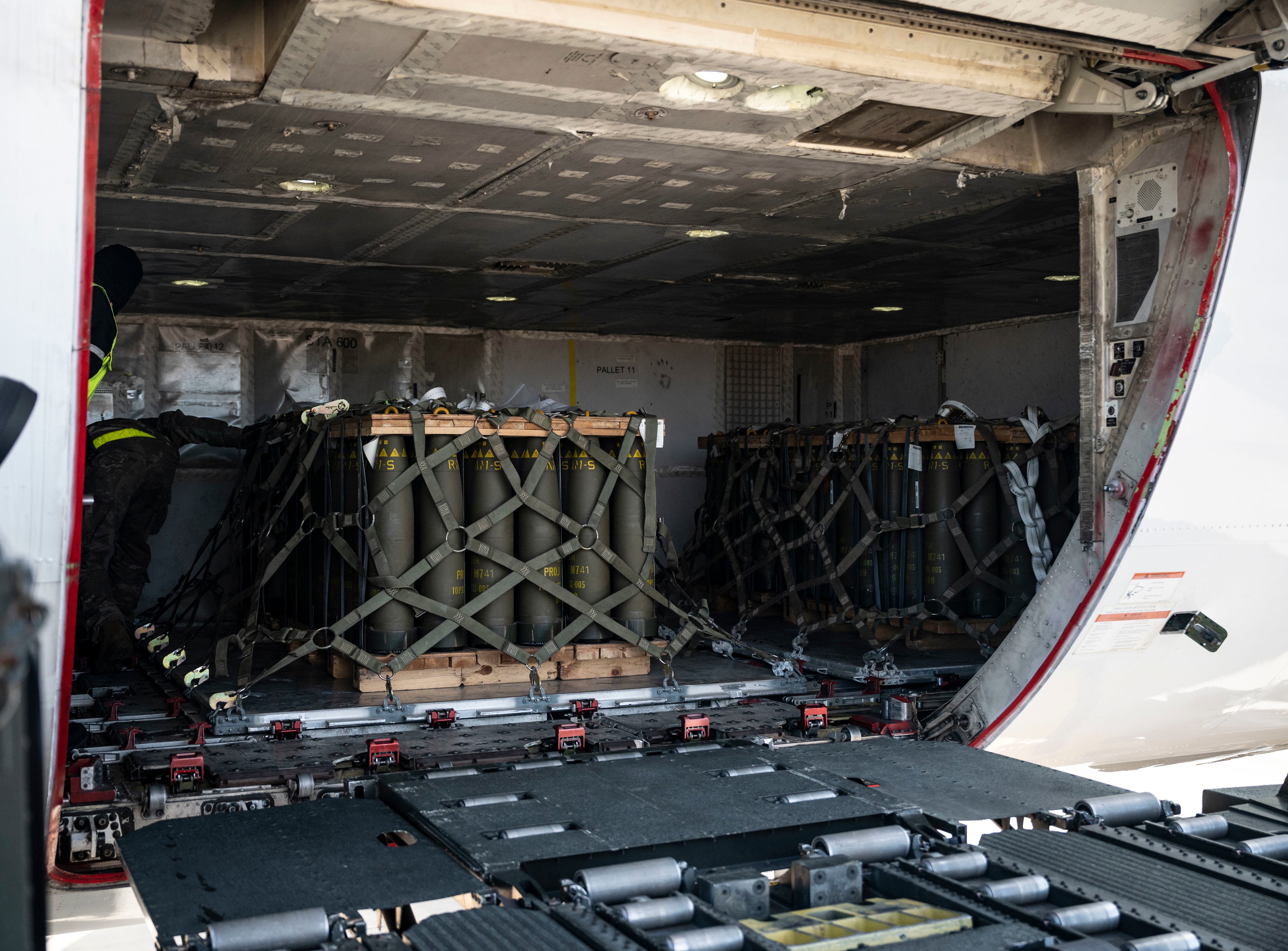 Pallets of ammunition, bound for Ukraine, are secured inside a commercial aircraft during a security assistance mission at Dover Air Force Base, Delaware, Feb. 3, 2023.