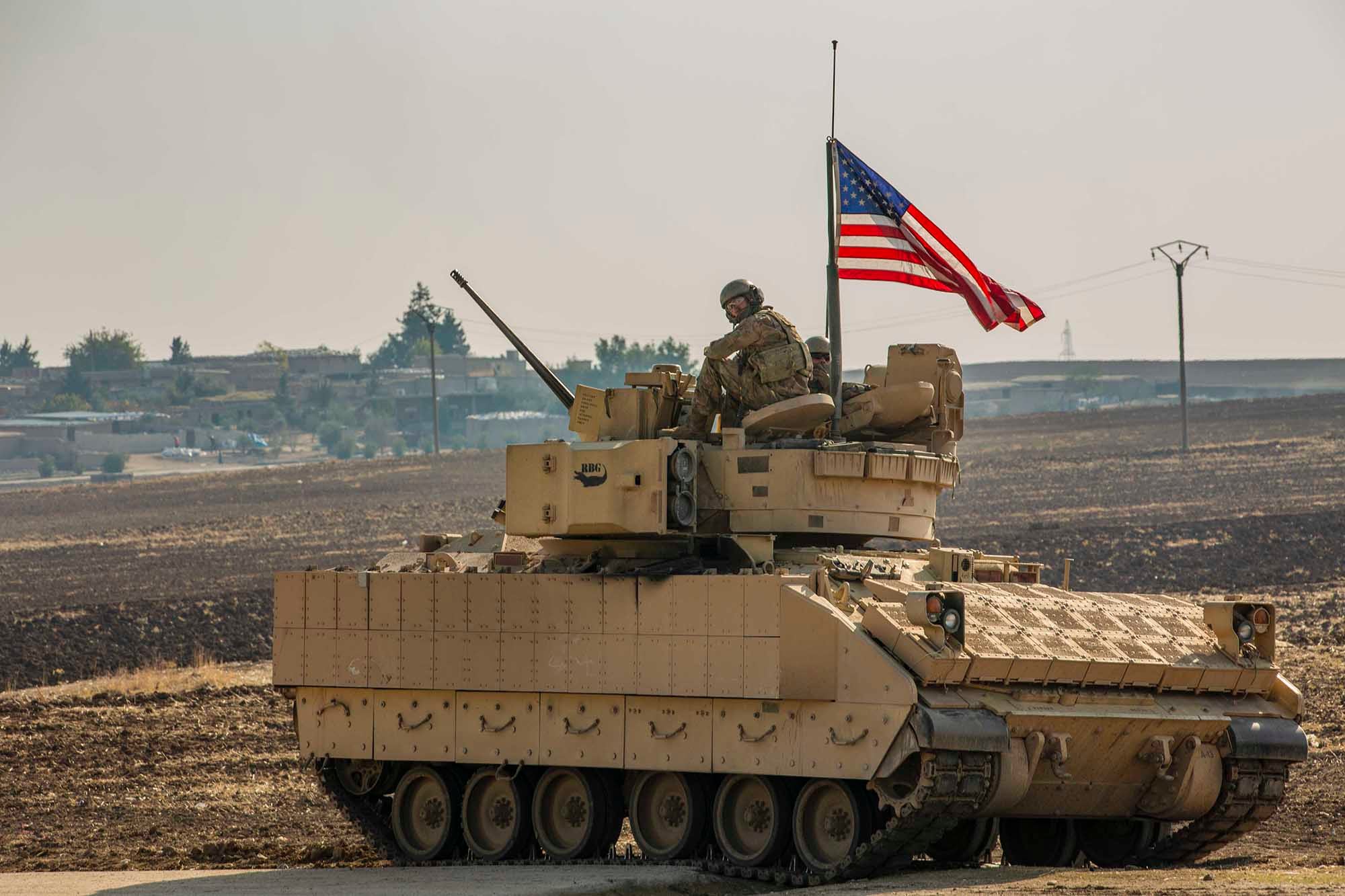 A U.S. soldier sits in the gunner’s seat of a M2 Bradley Infantry Fighting Vehicle in Syria in the Central Command  area of responsibility, Dec. 11, 2020.