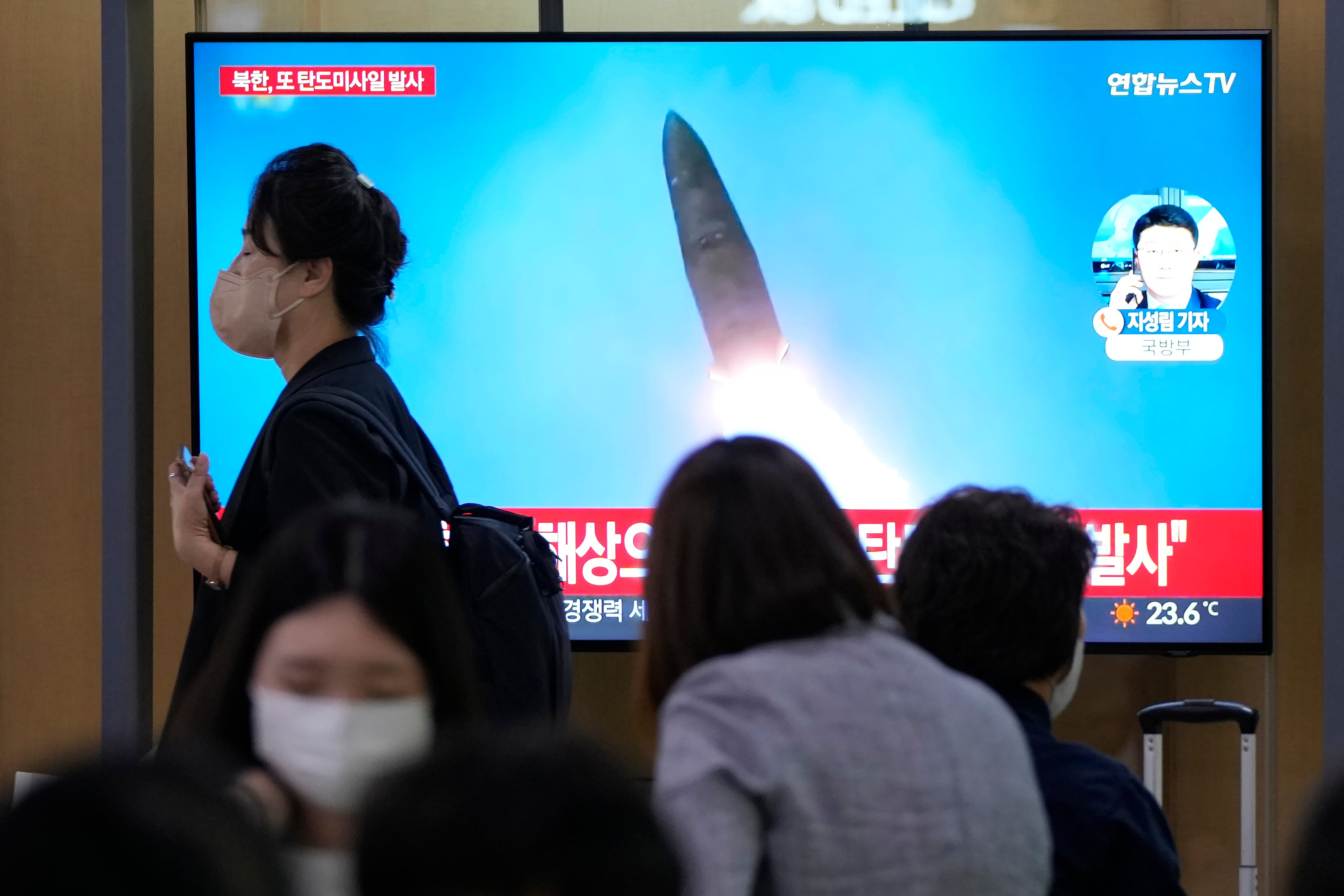 A TV screen shows a file image of a North Korean missile launch during a news program at the Seoul Railway Station in Seoul, South Korea, Wednesday, Sept. 28, 2022.