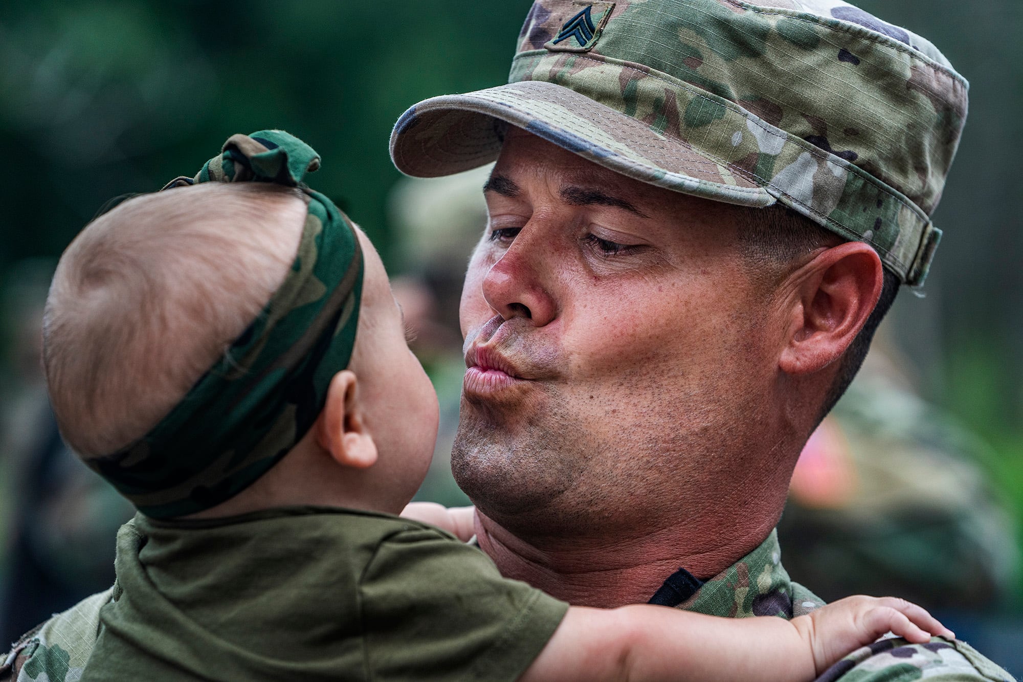 Sgt. Shawn Blakemore blows a kiss to his six-month old daughter Liv, Sunday, Aug. 9, 2020, as approximately 150 soldiers from the Stillwater-based 34th Military Police Company will deploy to Naval Station Guantanamo Bay in support of Joint Task Force Guantanamo to provide base security.