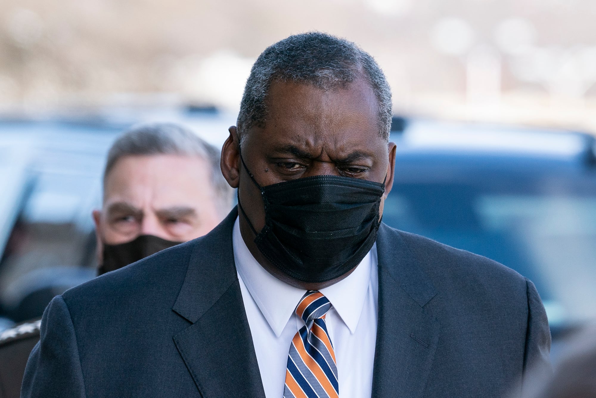 Defense Secretary Lloyd Austin arrives at the Pentagon, followed by Joint Chiefs Chairman Gen. Mark Milley on Jan. 22, 2021, in Washington.