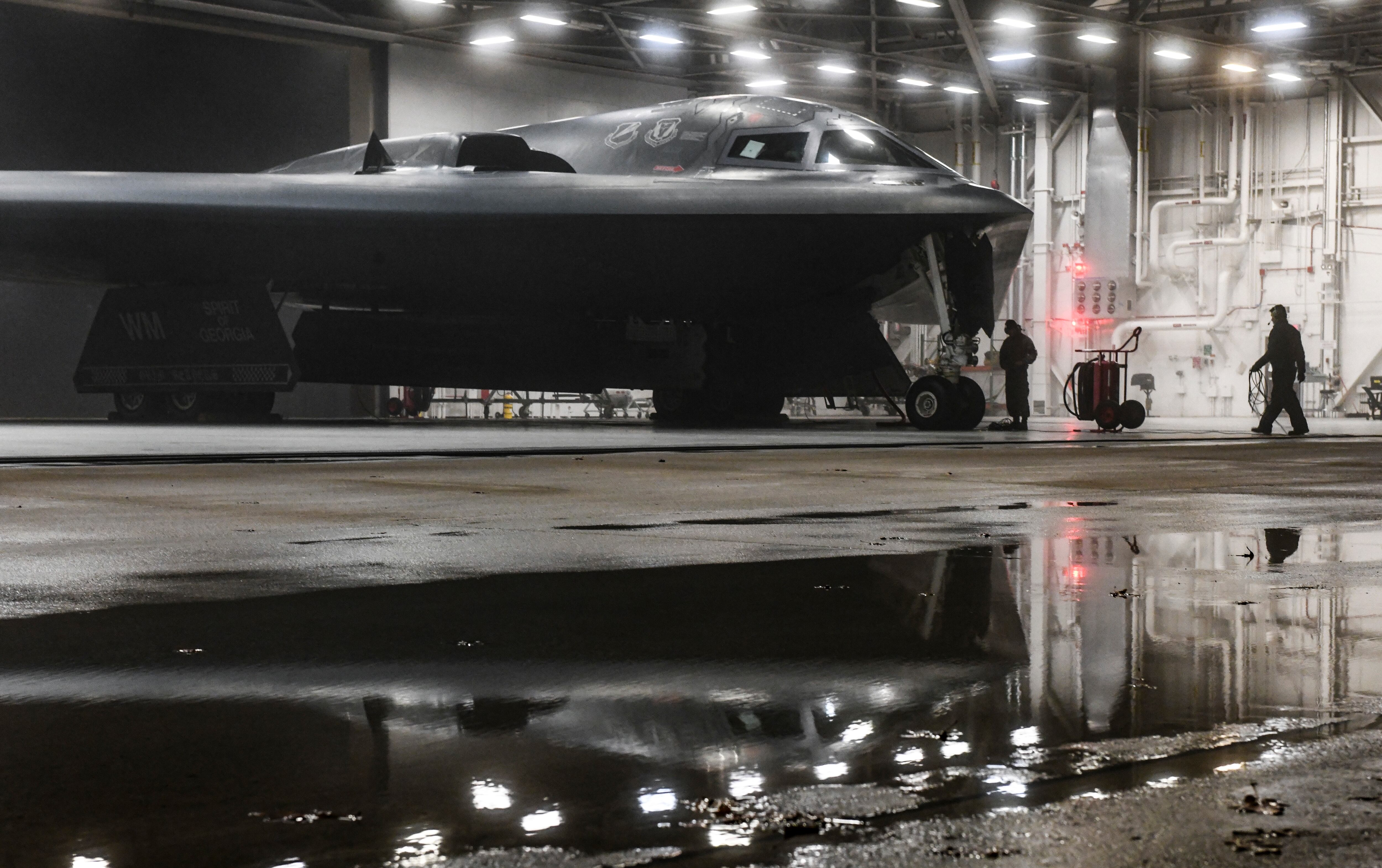 U.S. Air Force Senior Airman Tony Nogales, left, and Airman 1st Class Byron Humphrey, 509th Aircraft Maintenance Squadron crew chiefs, conclude preflight checks in support of a Bomber Task Force at Whiteman Air Force Base, Missouri, March 16, 2021. (Staff Sgt. Sadie Colbert/Air Force)