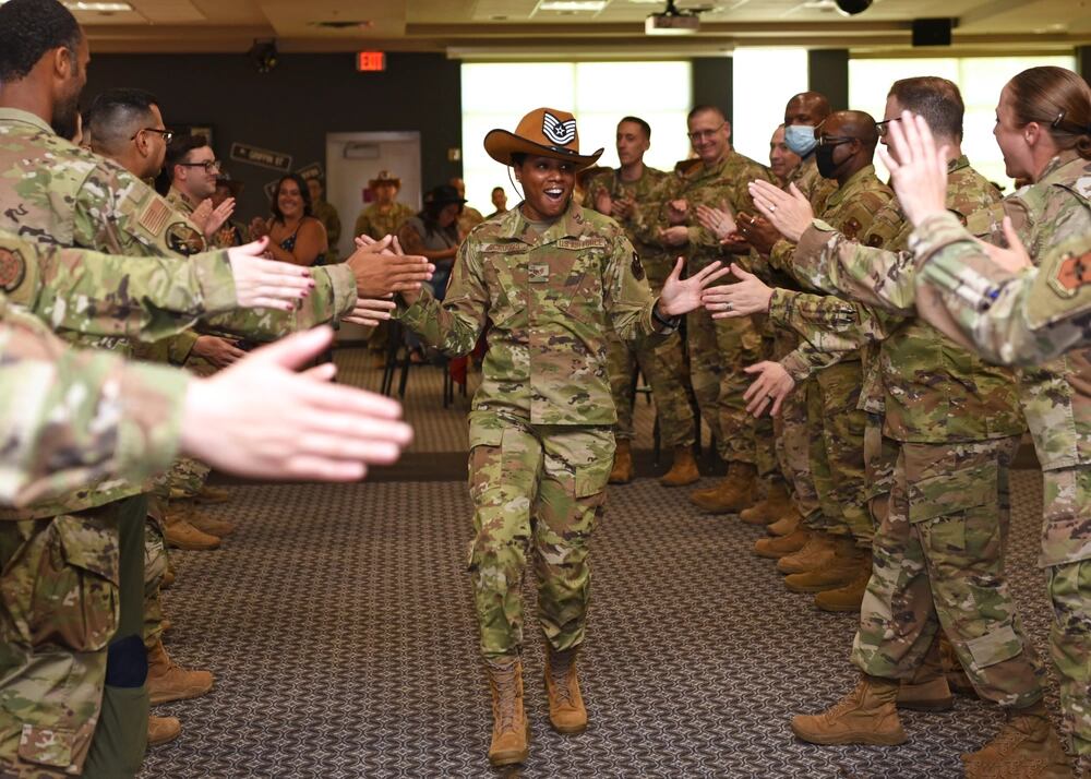 Staff Sgt. Sabrina Scruggs, 315th Training Squadron instructor, celebrates her achievement during the technical sergeant release party at Goodfellow Air Force Base, Texas, July 1, 2021. Coworkers and family members congratulated promotion selectees before they received their certificates. (Senior Airman Abbey Rieves/Air Force)