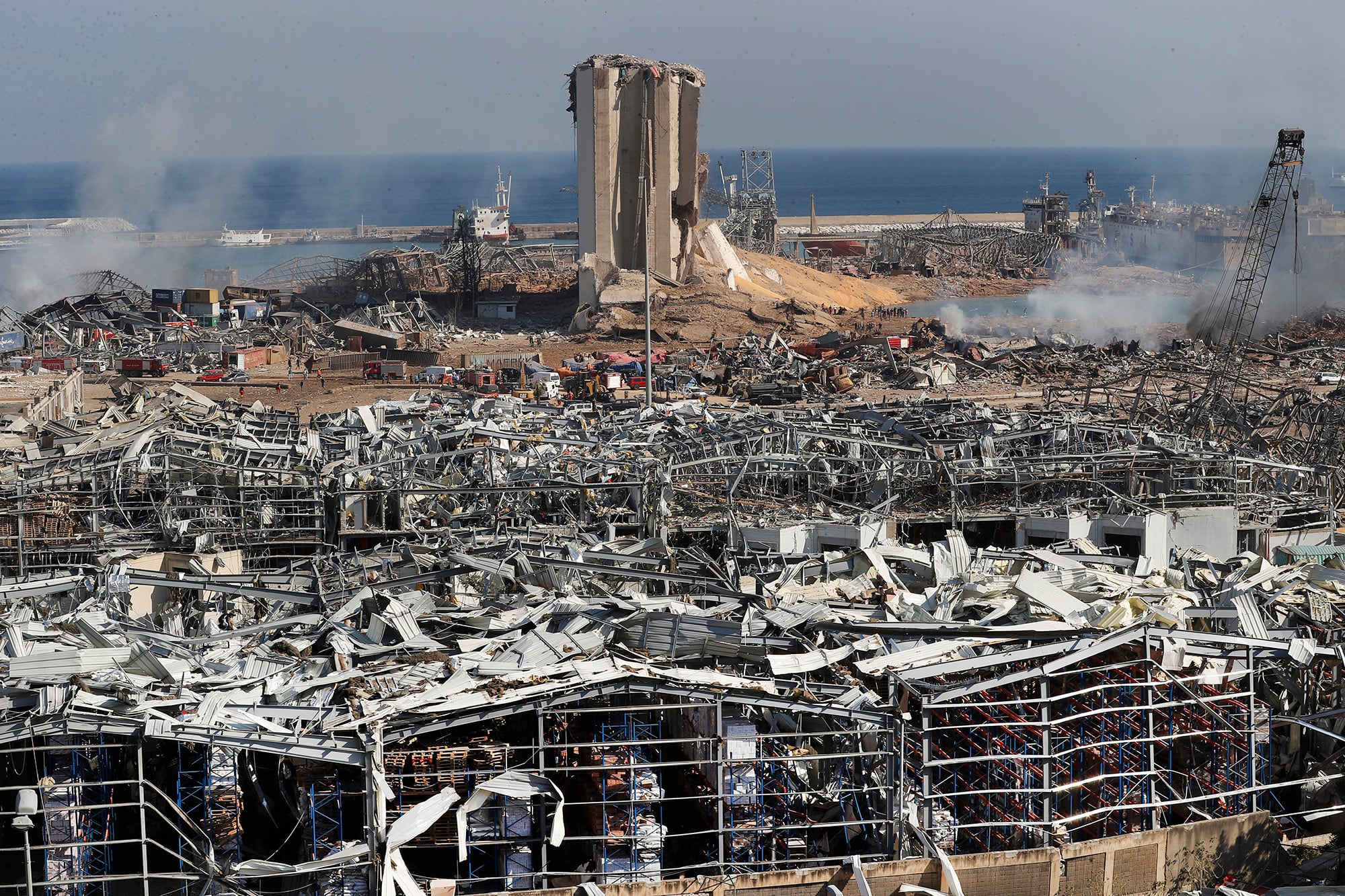 Rescue workers and security officers work at the scene of an explosion that hit the seaport of Beirut, Lebanon, Wednesday, Aug. 5, 2020.