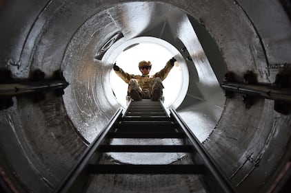 Senior Airman Zachariah Abdul-Aziz views his descent for a rappel down an entrance to a launch facility, Aug. 21, 2020, near Malmstrom Air Force Base, Mont.