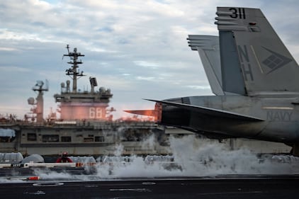 An F/A-18E Super Hornet launches from the flight deck of USS Theodore Roosevelt (CVN 71) while conducting dual-carrier operations with the Nimitz Carrier Strike Group in the South China Sea on Feb. 9, 2021.