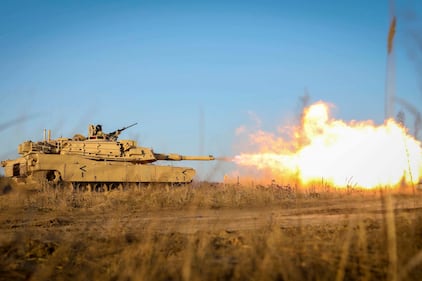 Gasses ignite as an M1 Abrams tank fires its main gun during a Dec. 10, 2020, live fire as part of the Ready to Fight operations after arriving to the Pabrade Training Area, Lithuania.