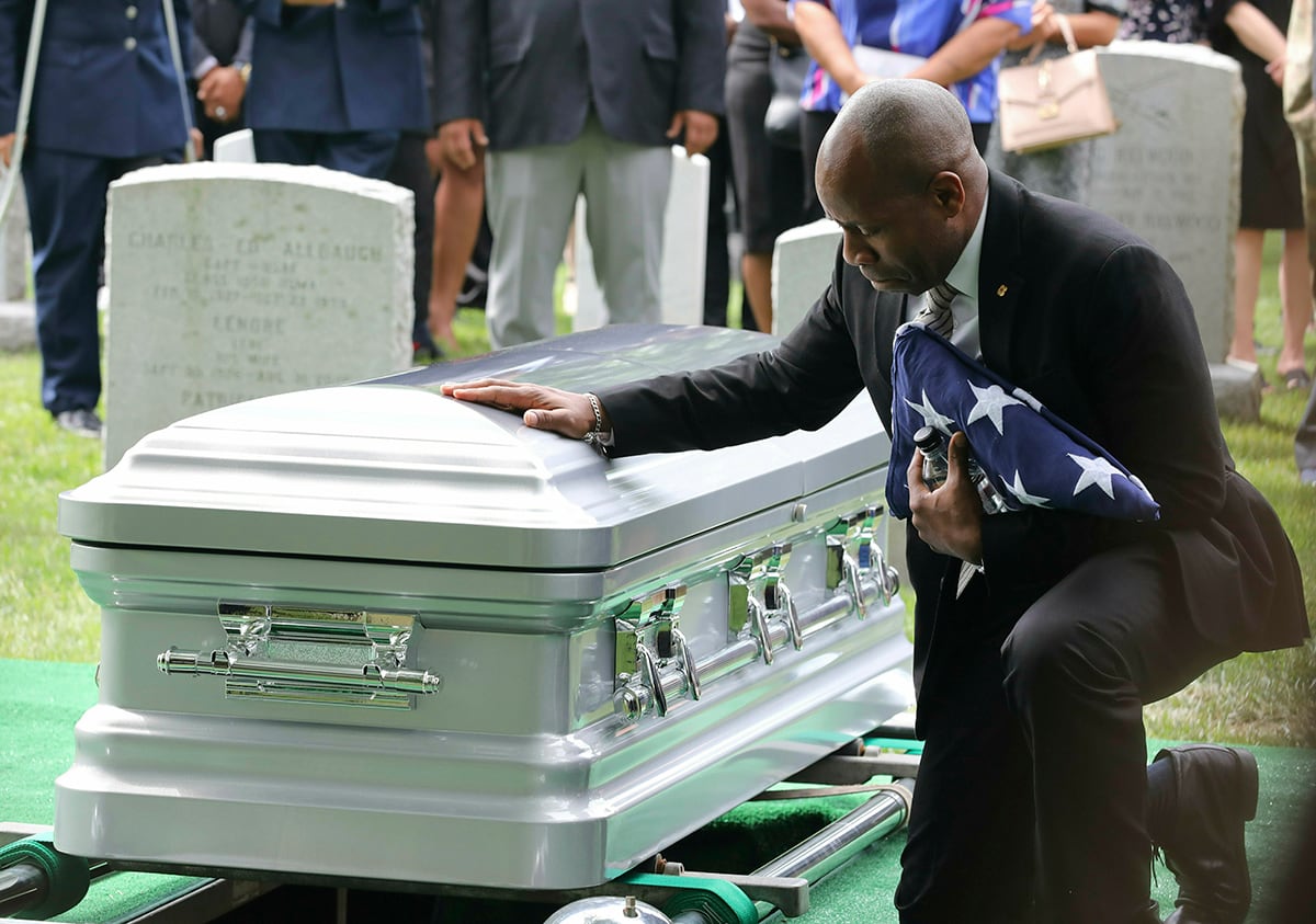 Christopher C. Morgan touches the casket of his son, West Point Cadet Christopher J. Morgan, during the interment ceremony at West Point, N.Y