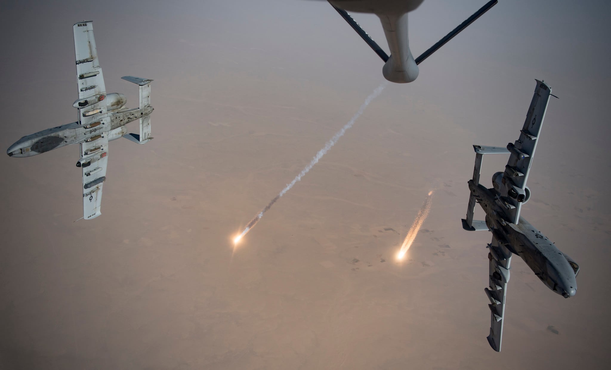 U.S. Air Force A-10 Thunderbolt IIs fire flares while breaking away after aerial refueling from a KC-135 Stratotanker out of Kandahar Airfield, Afghanistan, Aug. 15, 2019.