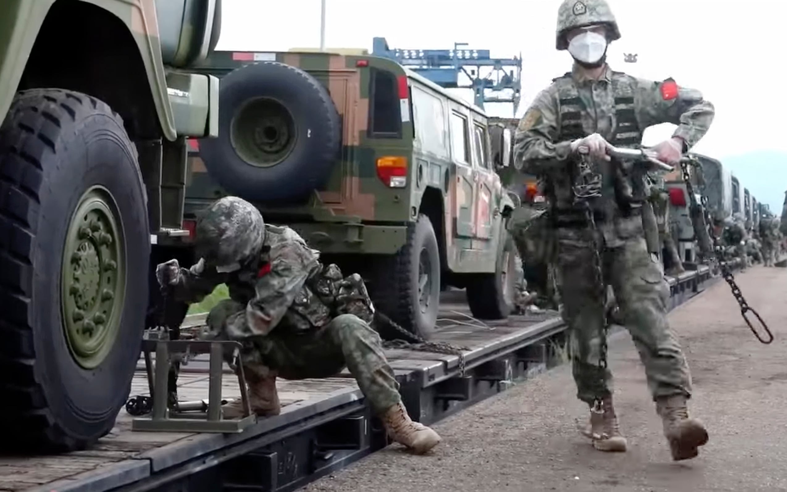 In this handout photo taken from video released by Russian Defense Ministry Press Service on Monday, Aug. 29, 2022, Chinese soldiers arrive to the Grodekovo railway station to participate in war games drills, in Grodekovo, Primorsky Krai, Russia.