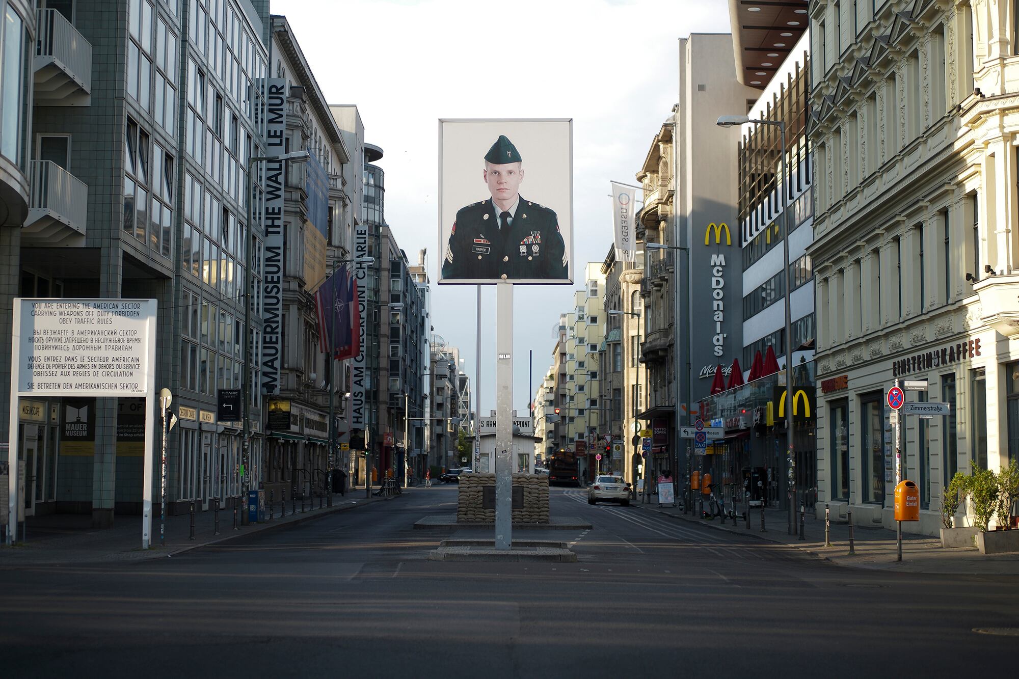 In this June 9, 2020, file photo, a picture of a former American soldier is displayed at the former U.S. Army Checkpoint Charlie in Berlin, Germany.