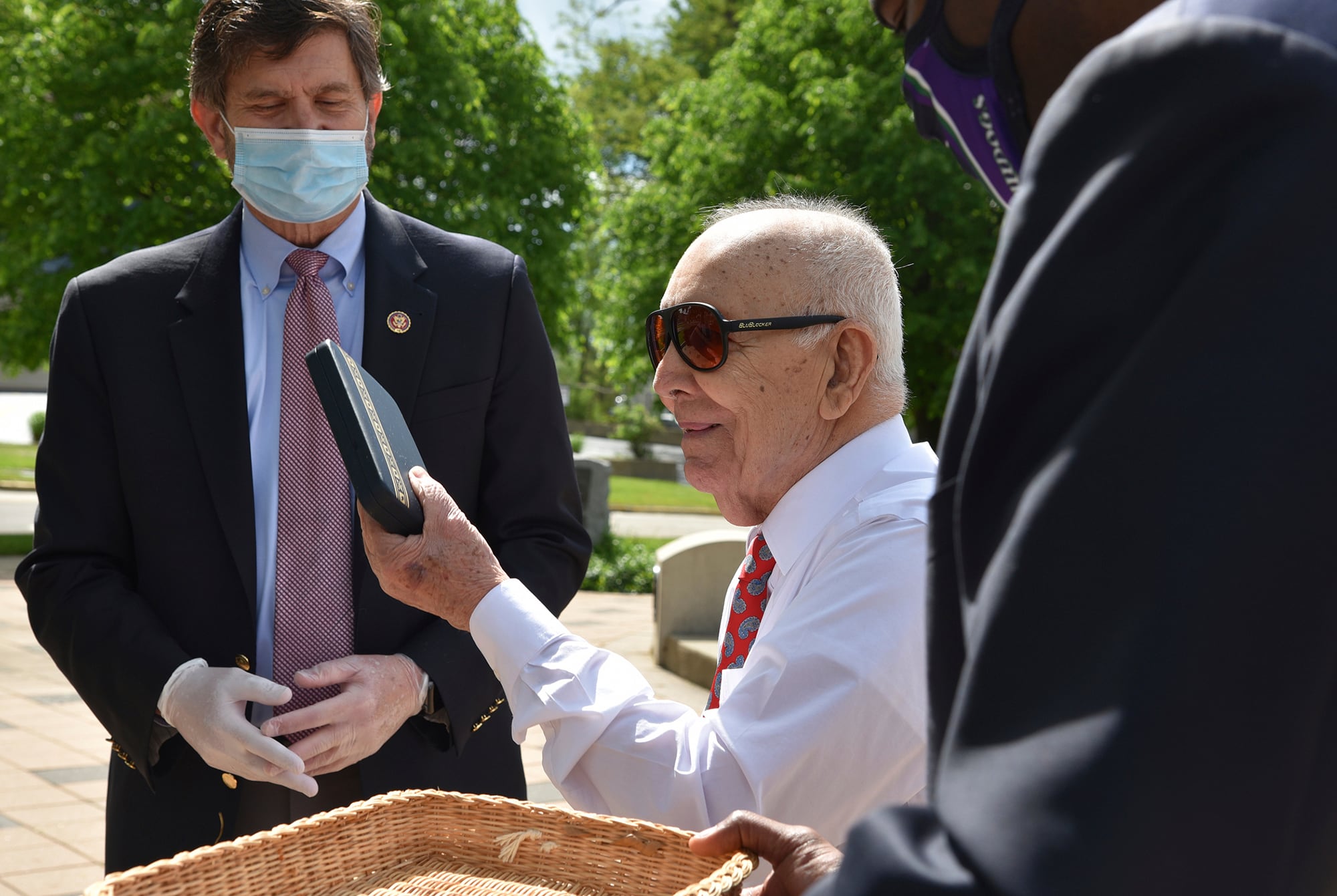 Marcos Montano, center, of Waukegan, Ill., holds up his replacement Purple Heart medal May 30, 2020, in Waukegan.