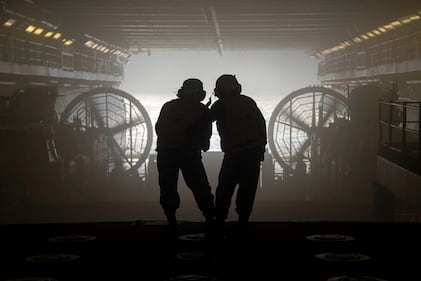 Boatswain’s Mate 2nd Class Cindy Maldonado, right, provides training to Boatswain’s Mate 3rd Class Lacy Duke on Jan. 19, 2021, during well deck operations aboard the Wasp-class amphibious assault ship USS Essex (LHD 2) in the Pacific Ocean.