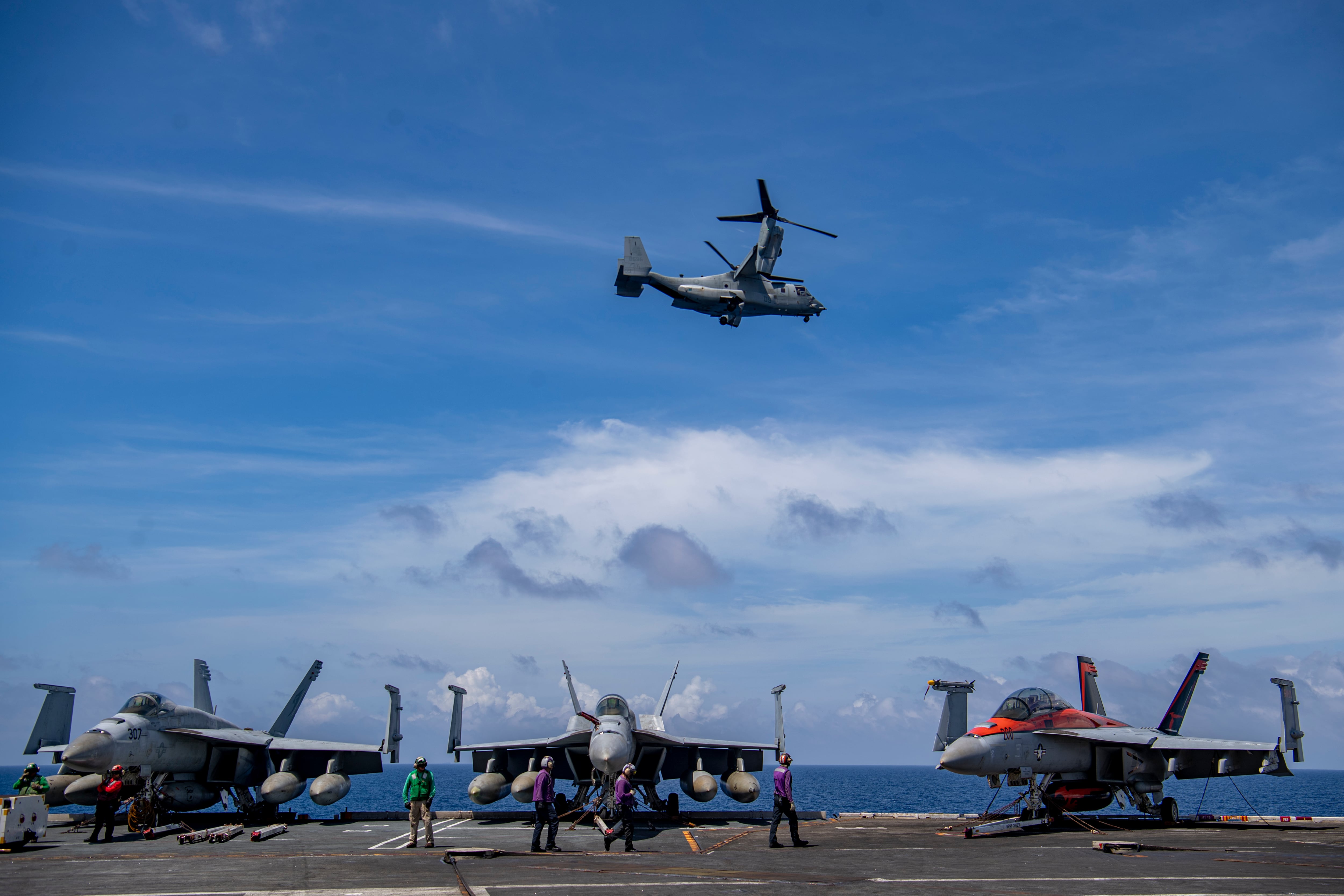 An MV-22 Osprey from the “Ugly Angels” of Marine Medium Tiltrotor Squadron 362 flies by the aircraft carrier Nimitz in the South China Sea, Feb. 11, 2023.