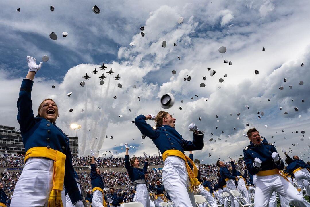 U.S. Air Force Academy cadets toss their caps at the end of a graduation ceremony in Colorado Springs, Colorado. More than 1,000 young adults graduated from the school on May 26, 2021. (Air Force photo)