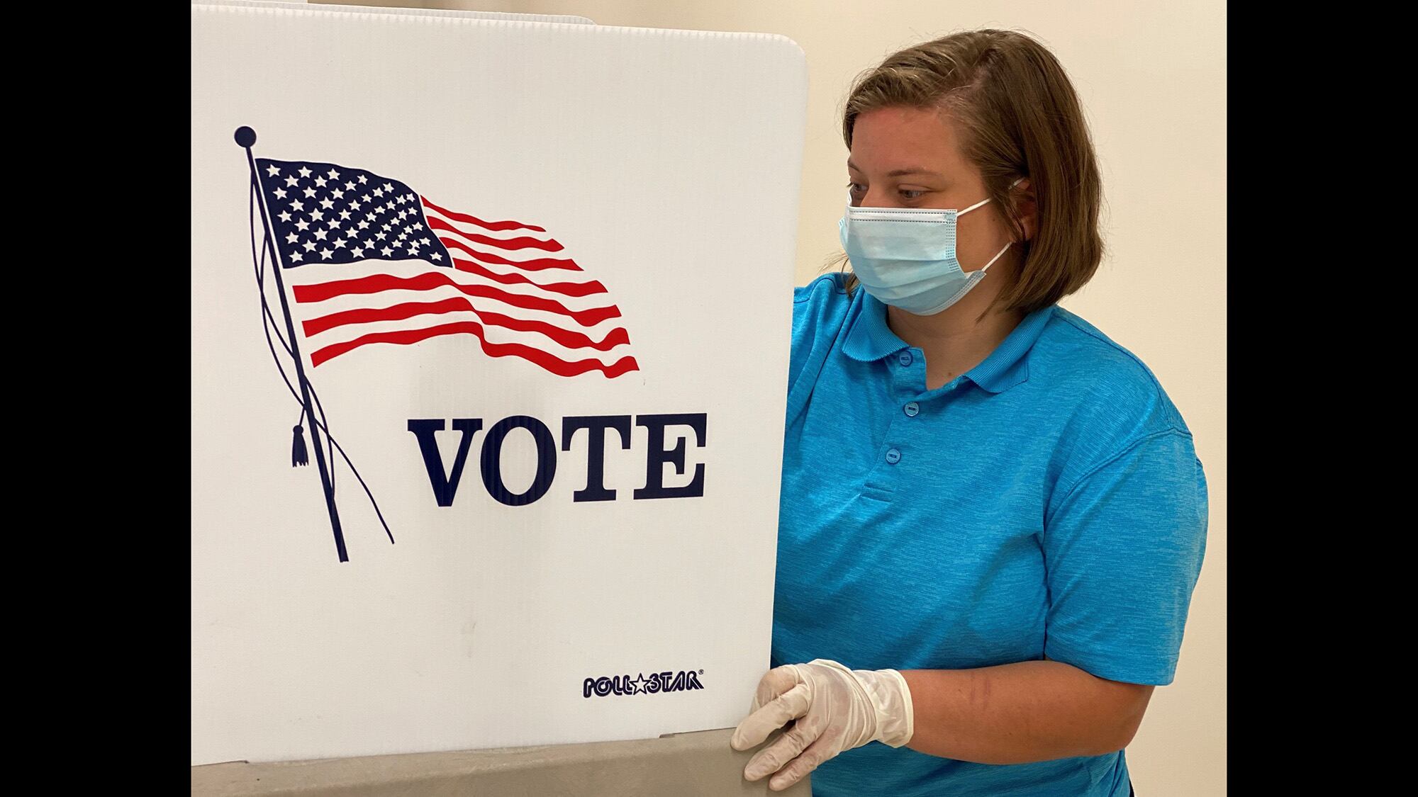 Reserve Officer Training Corps Cadet Alyssa Skorich sanitizes a voting station at the Anthony Stratton Building in Lawrenceburg, Ky., June 12, 2020.