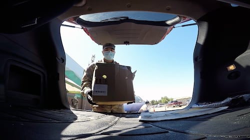 U.S. Army 1st Lt. Zachary Ota places a box of food into a vehicle Aug. 3, 2020, at the Merced County Food Bank in Merced, Calif.