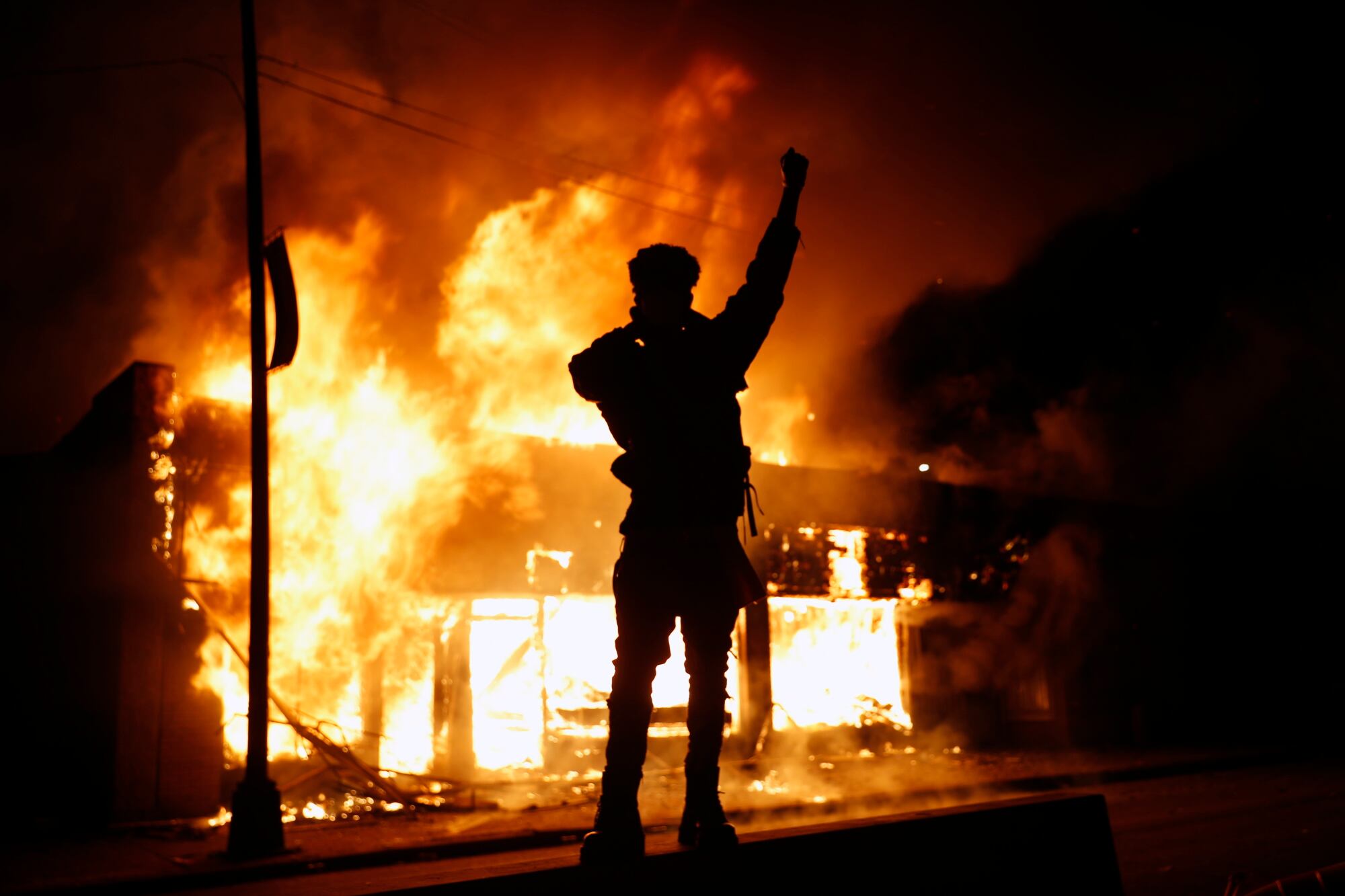 A check-cashing business burns Friday, May 29, 2020, in Minneapolis. Protests continued following the death of George Floyd, who died after being restrained by Minneapolis police officers on Memorial Day.