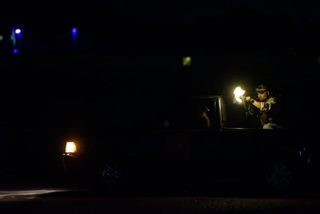 A role-player fires blanks at Special Forces candidates as the candidates approach their final "combat target" at Curtis L. Brown, Jr. Field Airport in Elizabethtown, Tuesday, Sept. 29, 2023, during the final phase of field training known as Robin Sage.