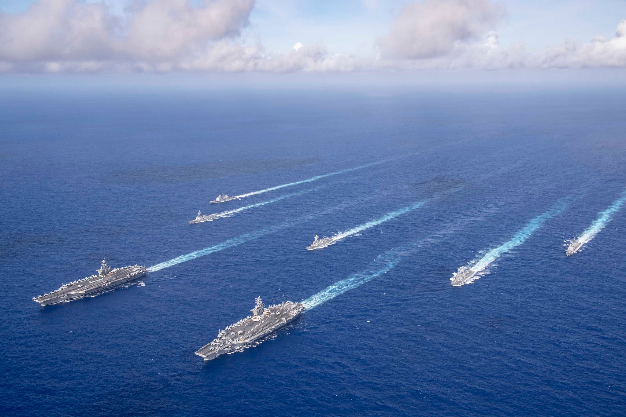 The Theodore Roosevelt and Nimitz carrier strike groups transit the Philippine Sea in formation while conducting dual carrier and airwing operations on June 23, 2020.