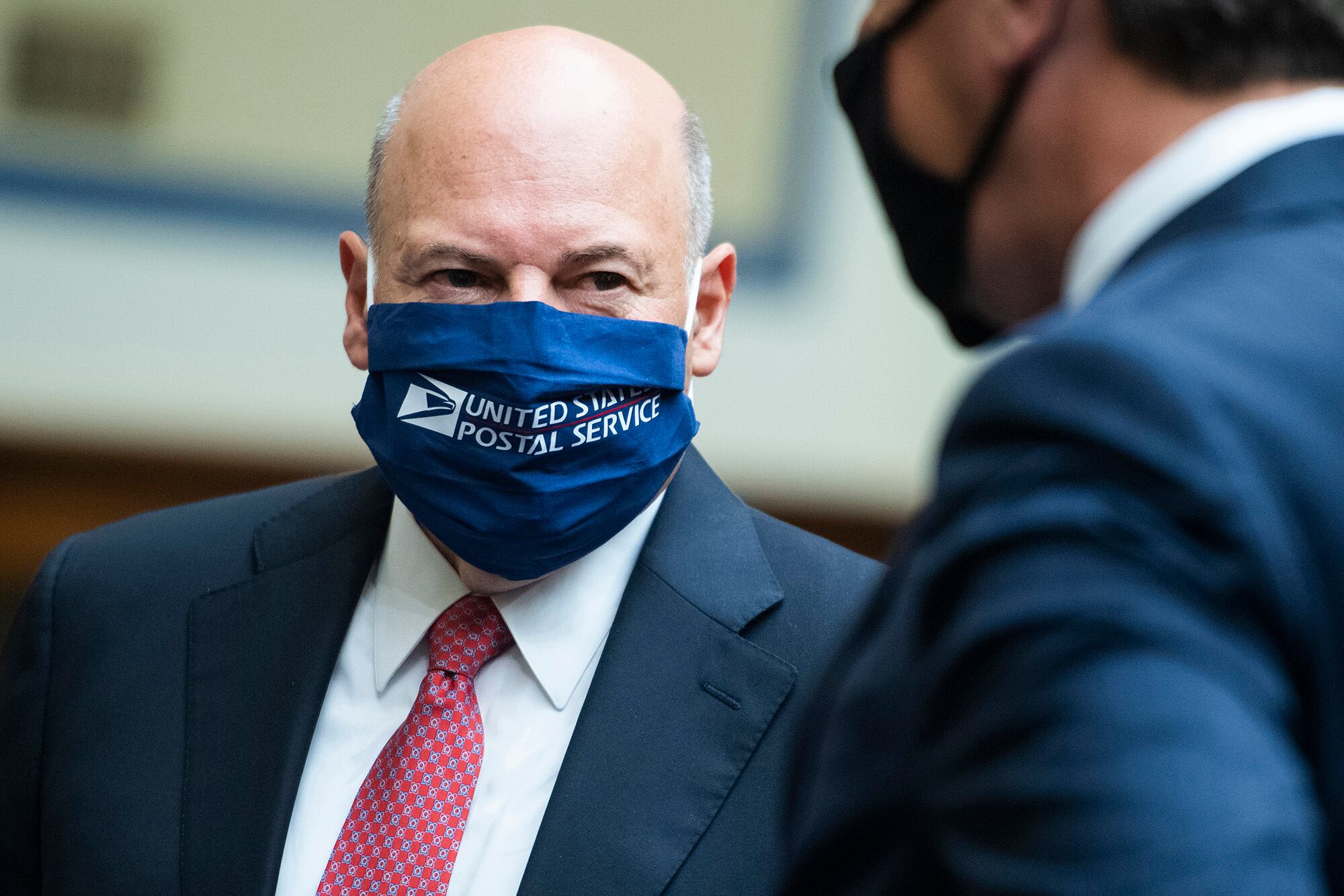 Postmaster General Louis DeJoy, left, talks with Rep. Mark Walker, R-N.C., before a House Oversight and Reform Committee hearing on the Postal Service on Capitol Hill, Monday, Aug. 24, 2020, in Washington.